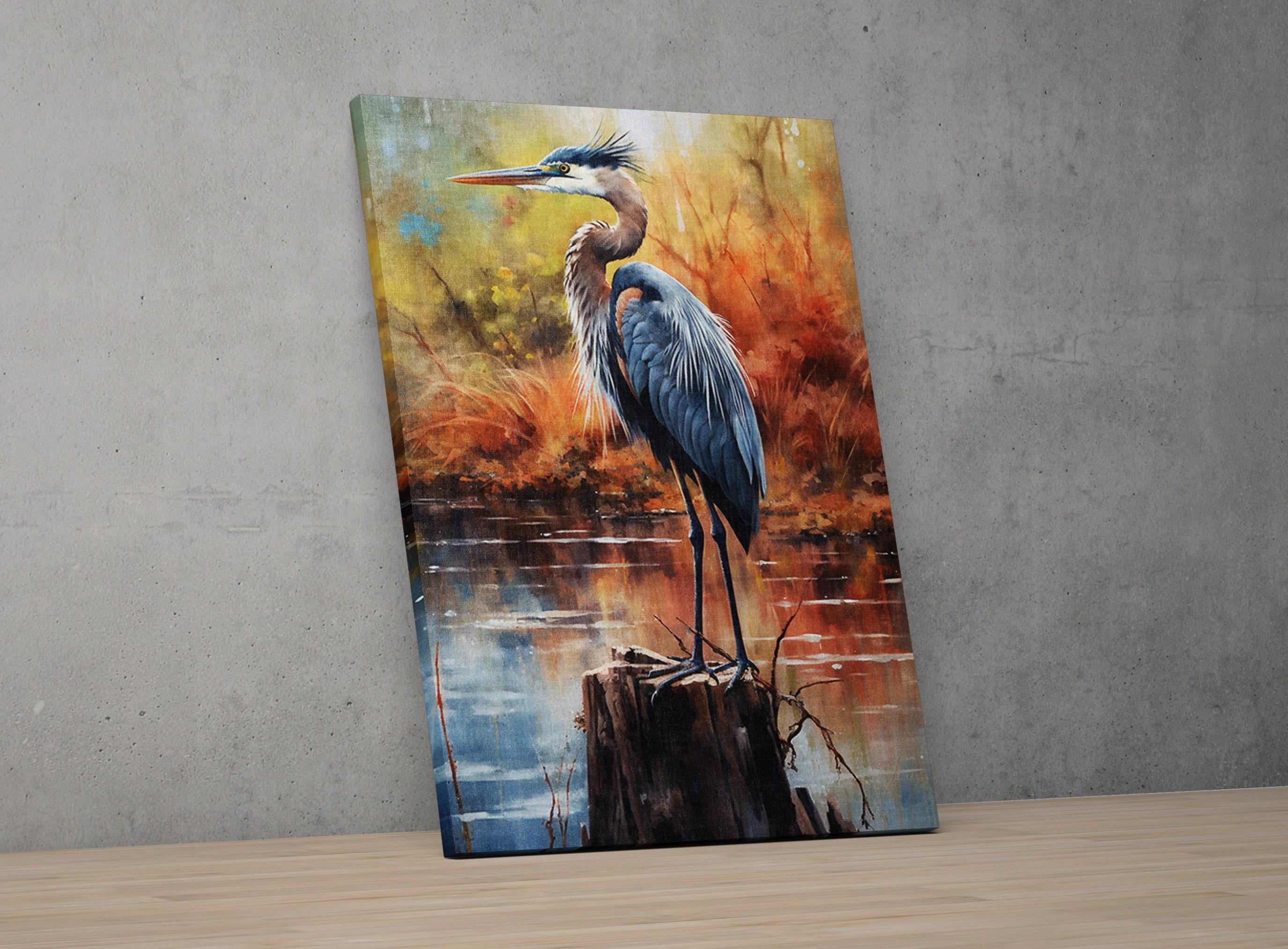 A painting of a blue heron standing on a tree stump in a natural setting, with a colorful background depicting autumn foliage.