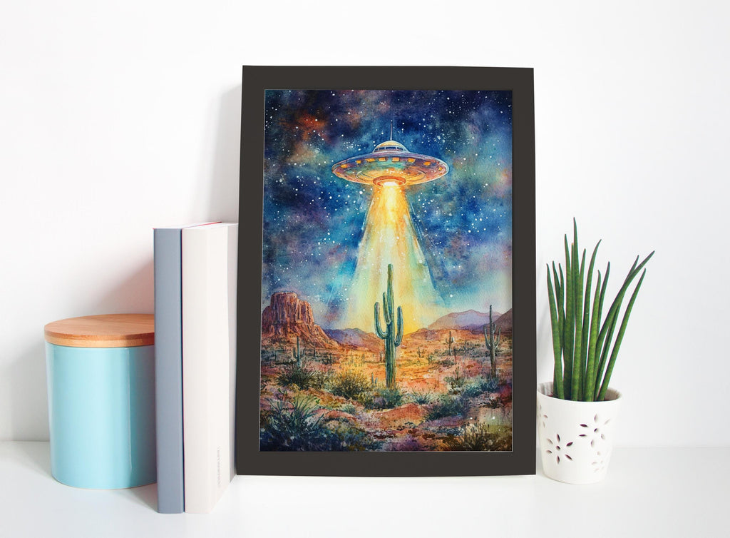 a framed painting of a desert landscape with a cactus and a large alien spacecraft hovering above it, set against a starry night sky.