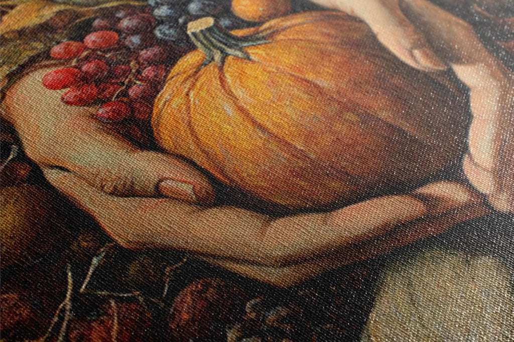 A close-up of a hand holding a large orange pumpkin, with some grapes and a smaller pumpkin visible in the background.