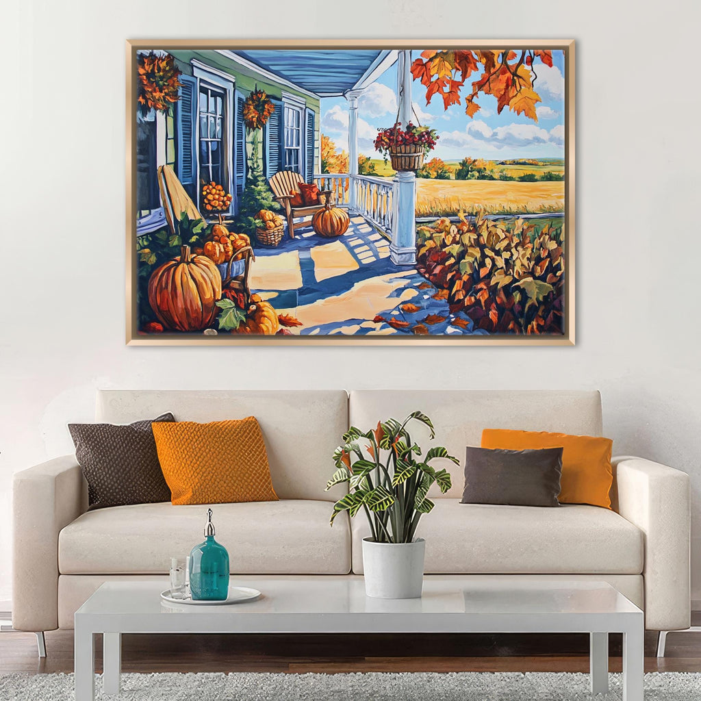 a cozy living room with a white sofa adorned with orange and brown throw pillows, a coffee table with a blue vase and a white plant, and a large painting of a porch with pumpkins and fall foliage hanging above the sofa.