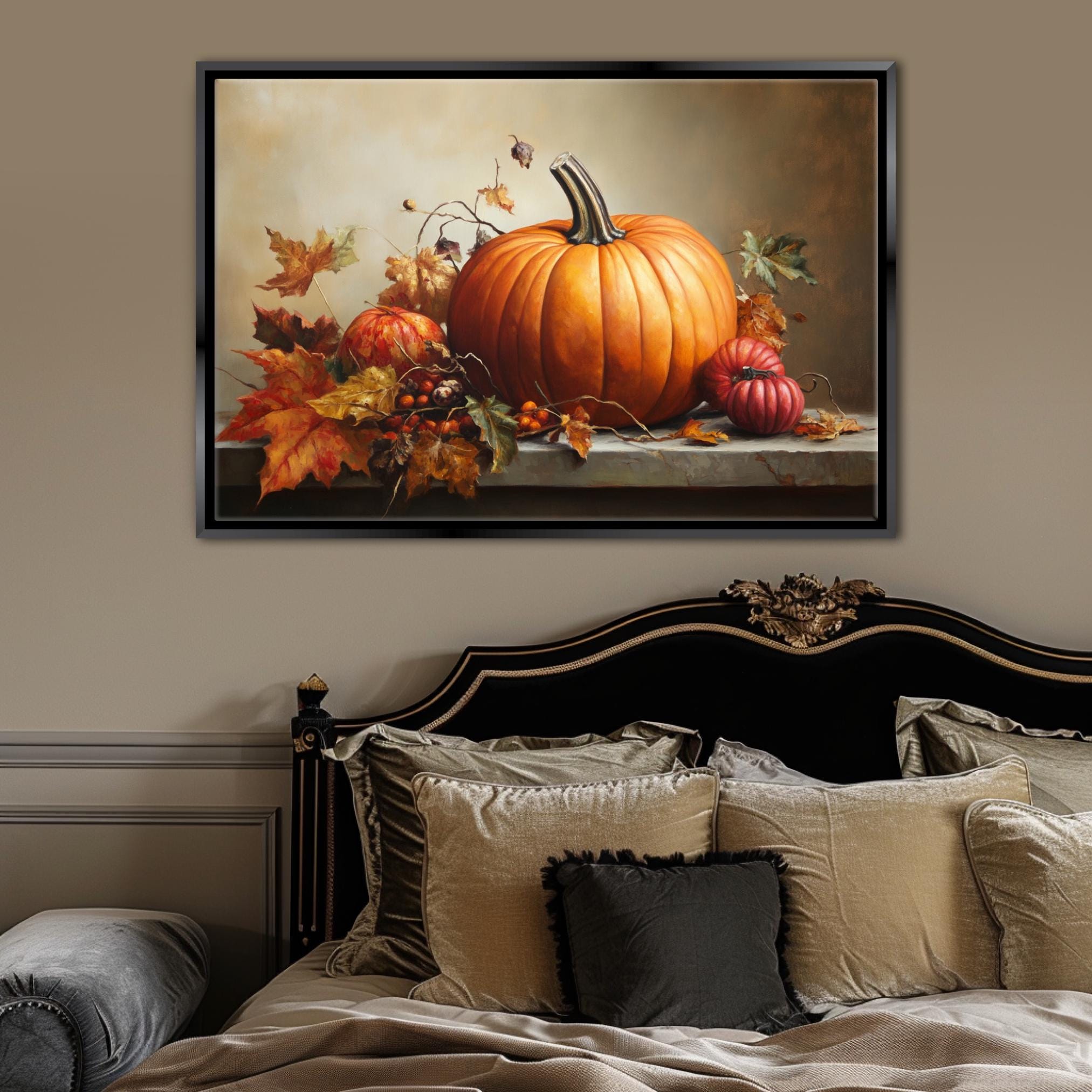a large framed painting of a pumpkin and autumn leaves on a wall above a bed with a black headboard and beige bedding.
