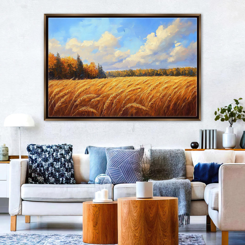 a large painting of a field of golden wheat against a blue sky with clouds, hanging on a wall above a white sofa with various throw pillows.