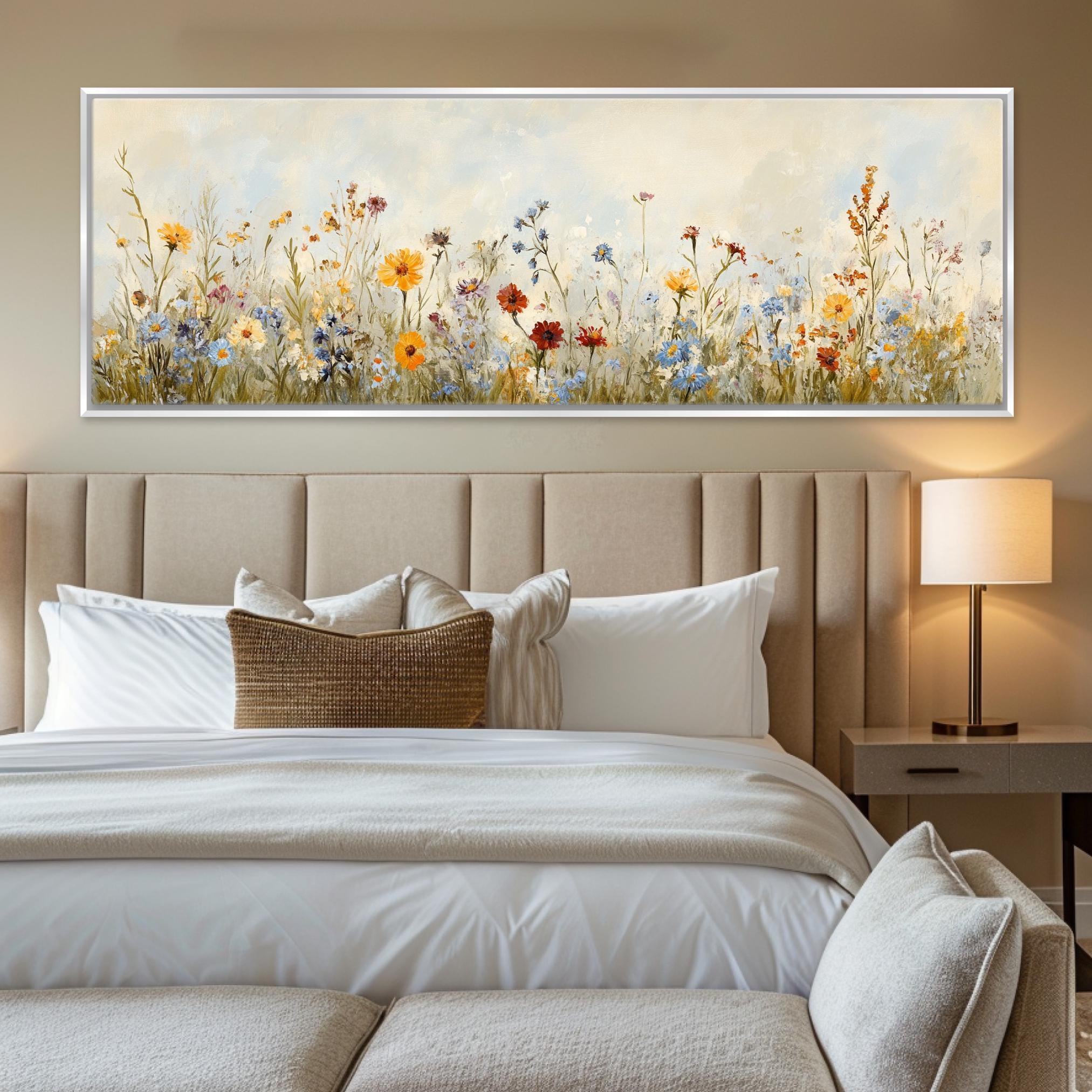 a bed with a white comforter and a painting on the wall above it