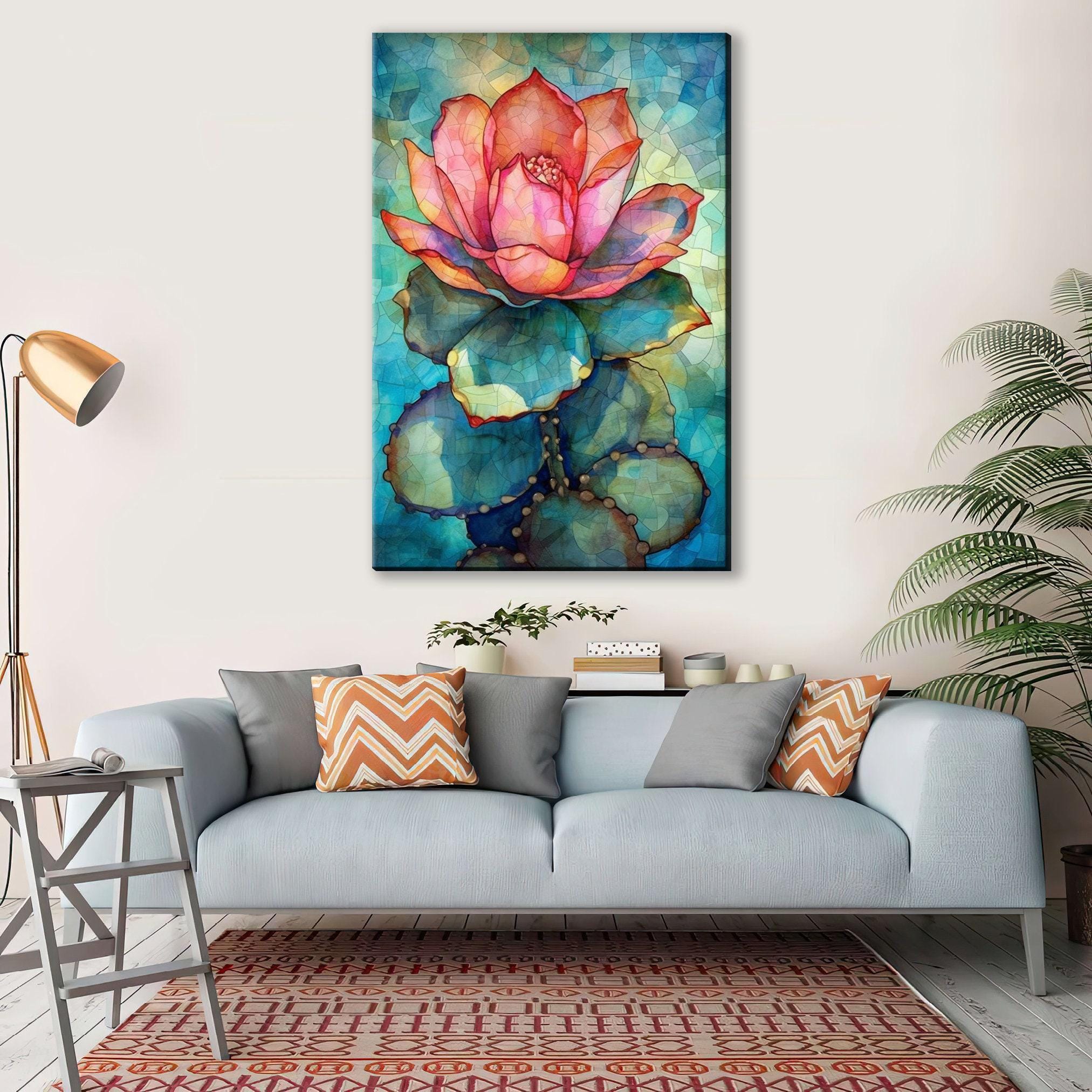 a large, colorful painting of a cactus flower hanging on a wall above a gray couch with patterned pillows.