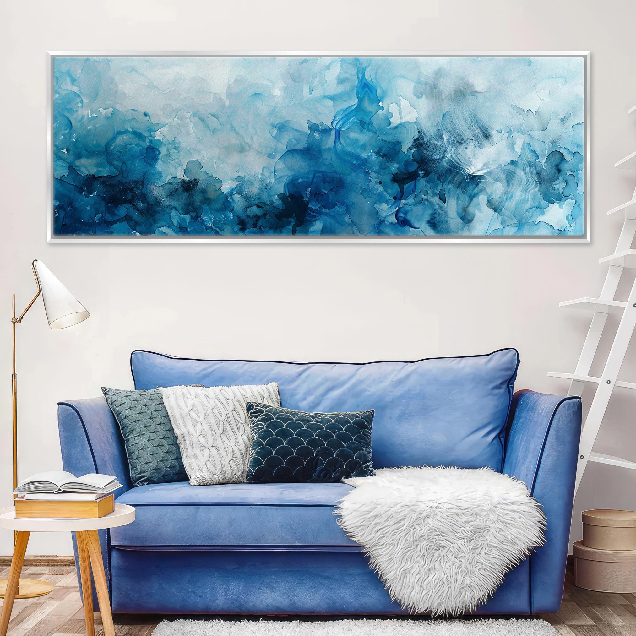 a living room with a blue couch and a painting on the wall