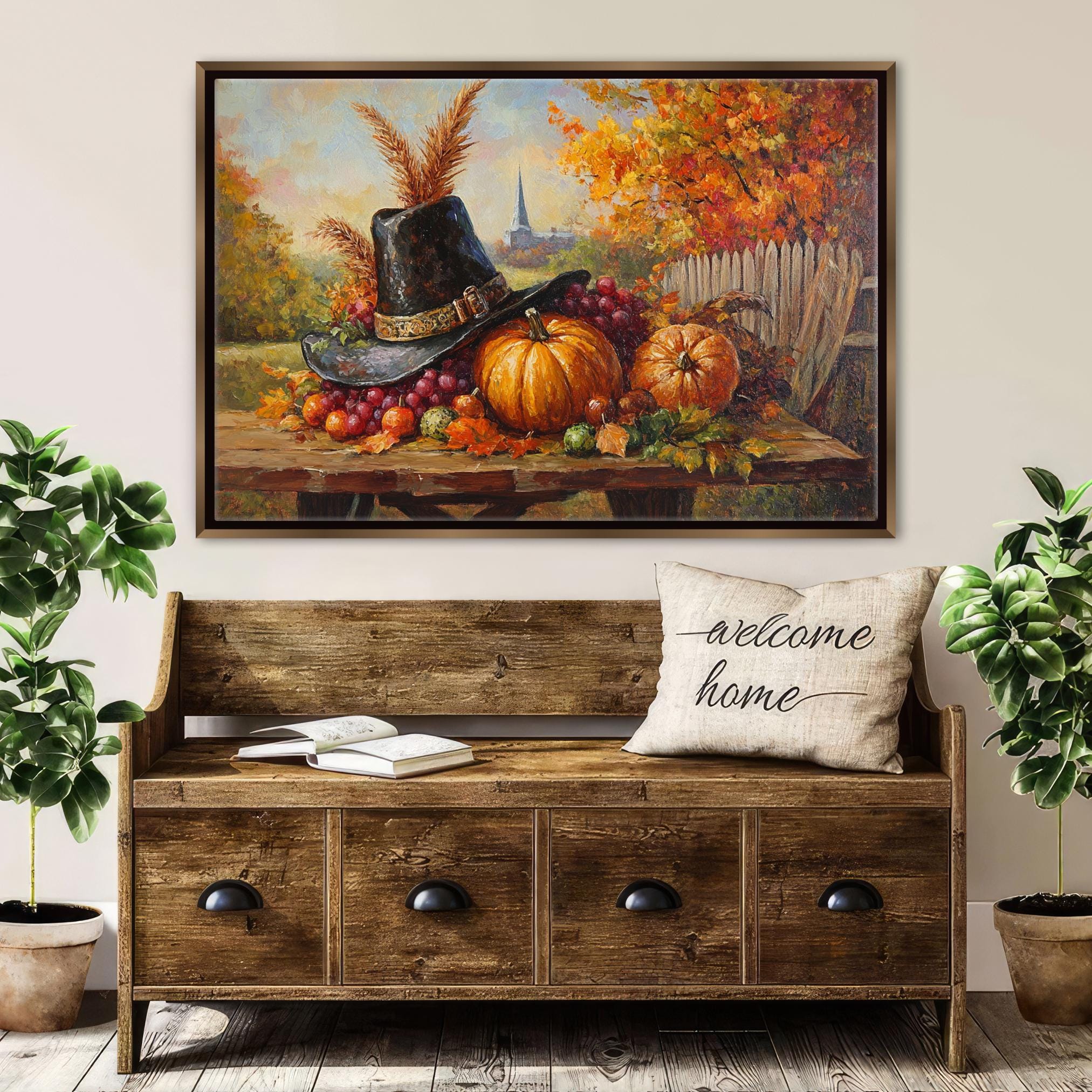 a wooden bench with a "welcome home" pillow, a painting of a table with a hat, pumpkins, and other fall fruits, and two potted plants on either side of the bench.