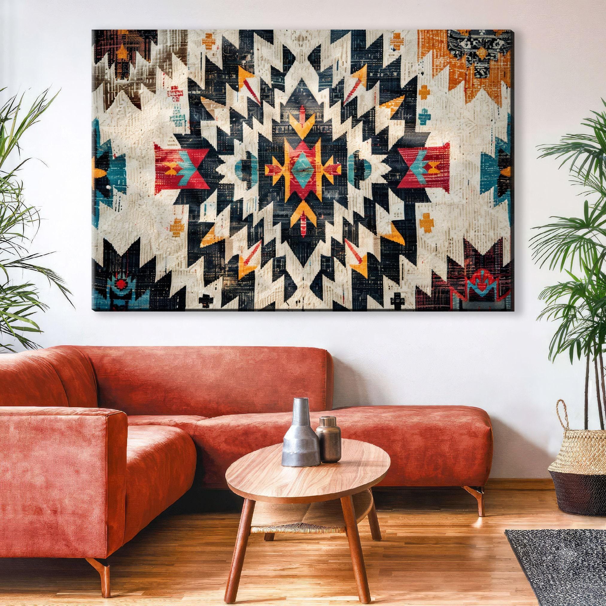a large, colorful, abstract patterned wall hanging in a living room setting. The wall hanging is positioned above a red couch and a wooden coffee table.