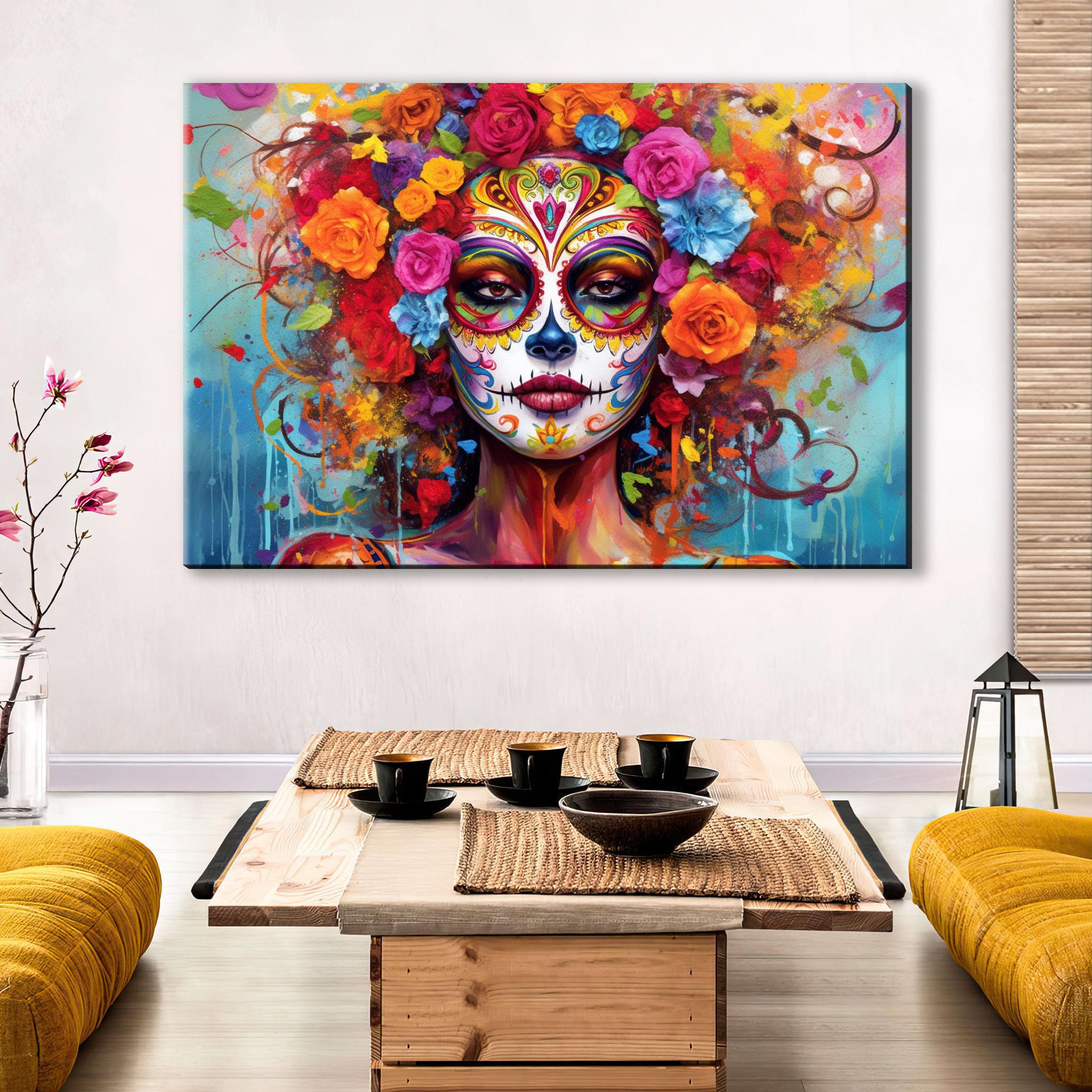 a large, colorful painting of a woman's face with intricate floral designs and patterns surrounding her. The painting is displayed on a wall above a wooden coffee table, which has a bowl and a vase on it. The room has a cozy, inviting atmosphere with yellow couches and a wooden floor.