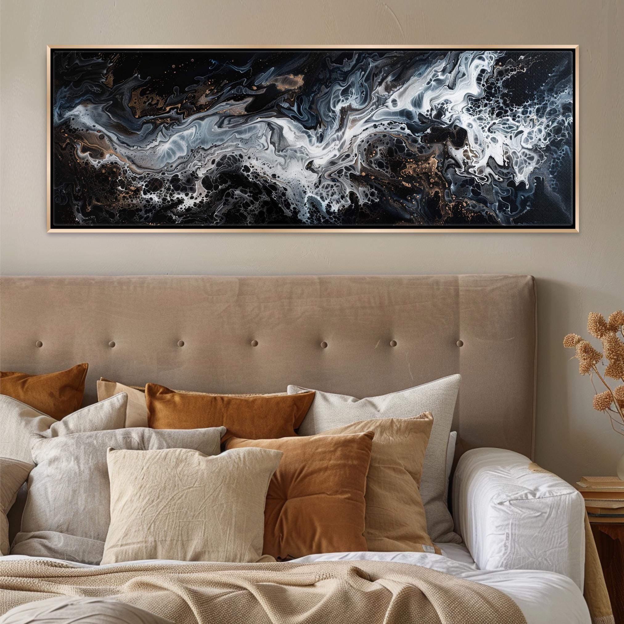 a bed with a large painting on the wall above it