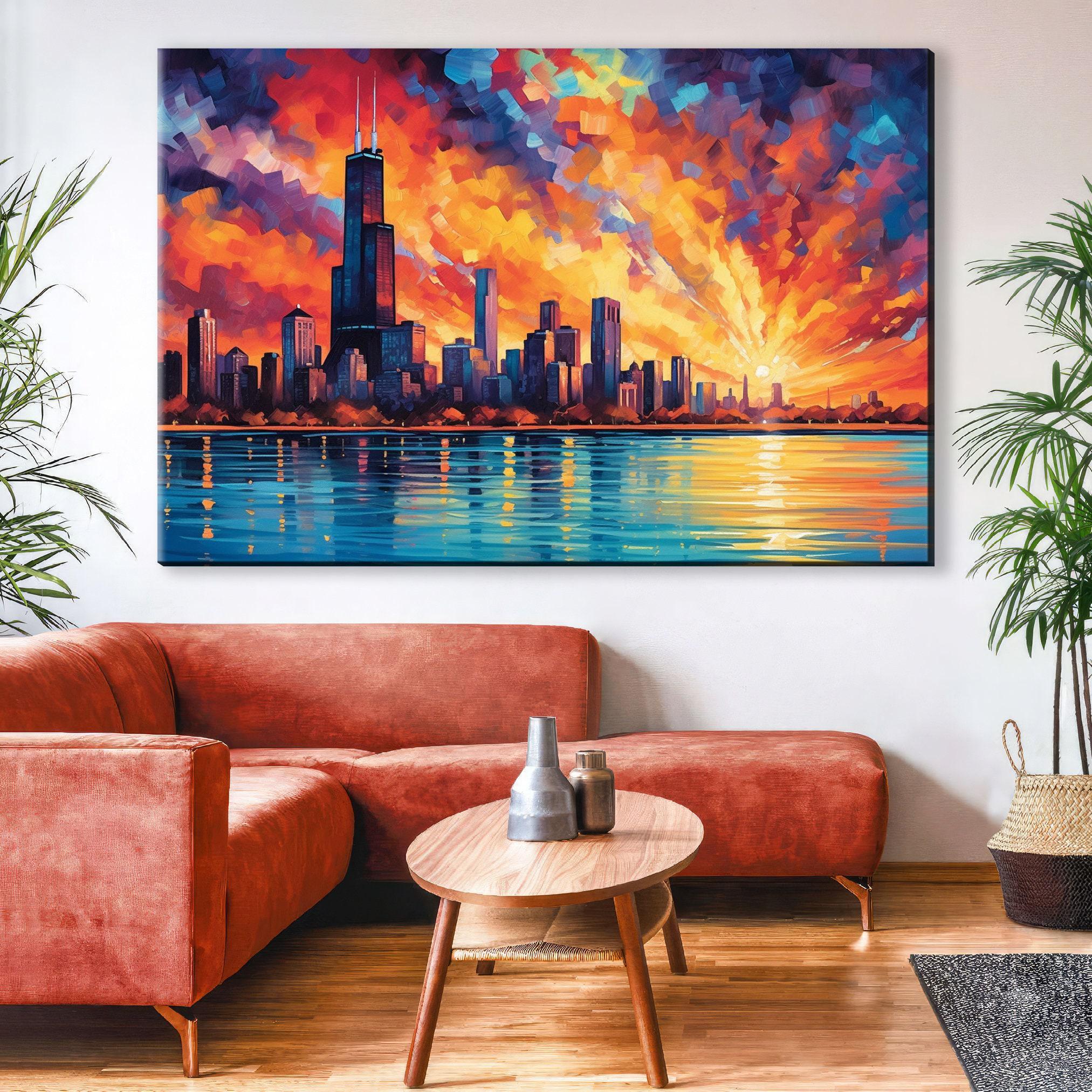 a large, colorful painting of a city skyline with a sunset over the water, hanging on a wall above a red sofa and a wooden coffee table in a living room setting.