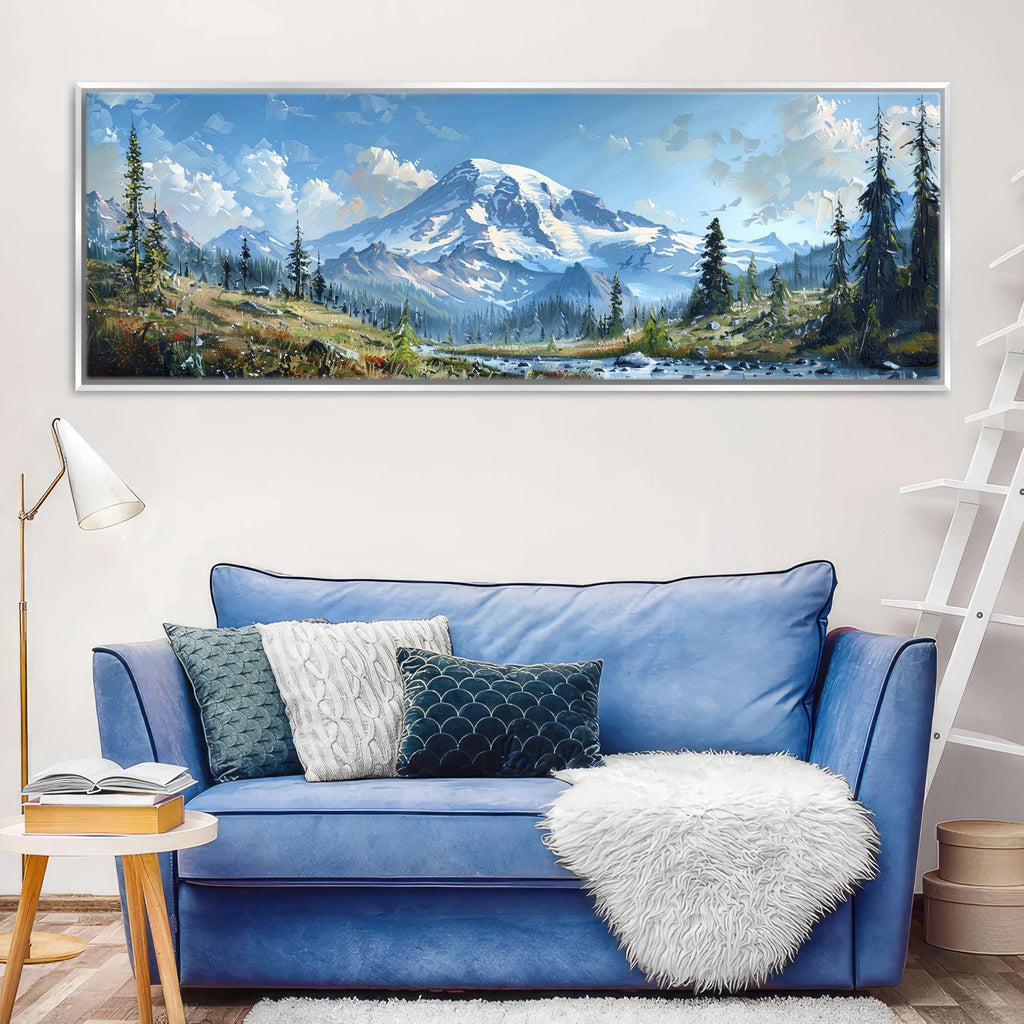 a large landscape painting hanging on a wall above a blue sofa with decorative pillows.
