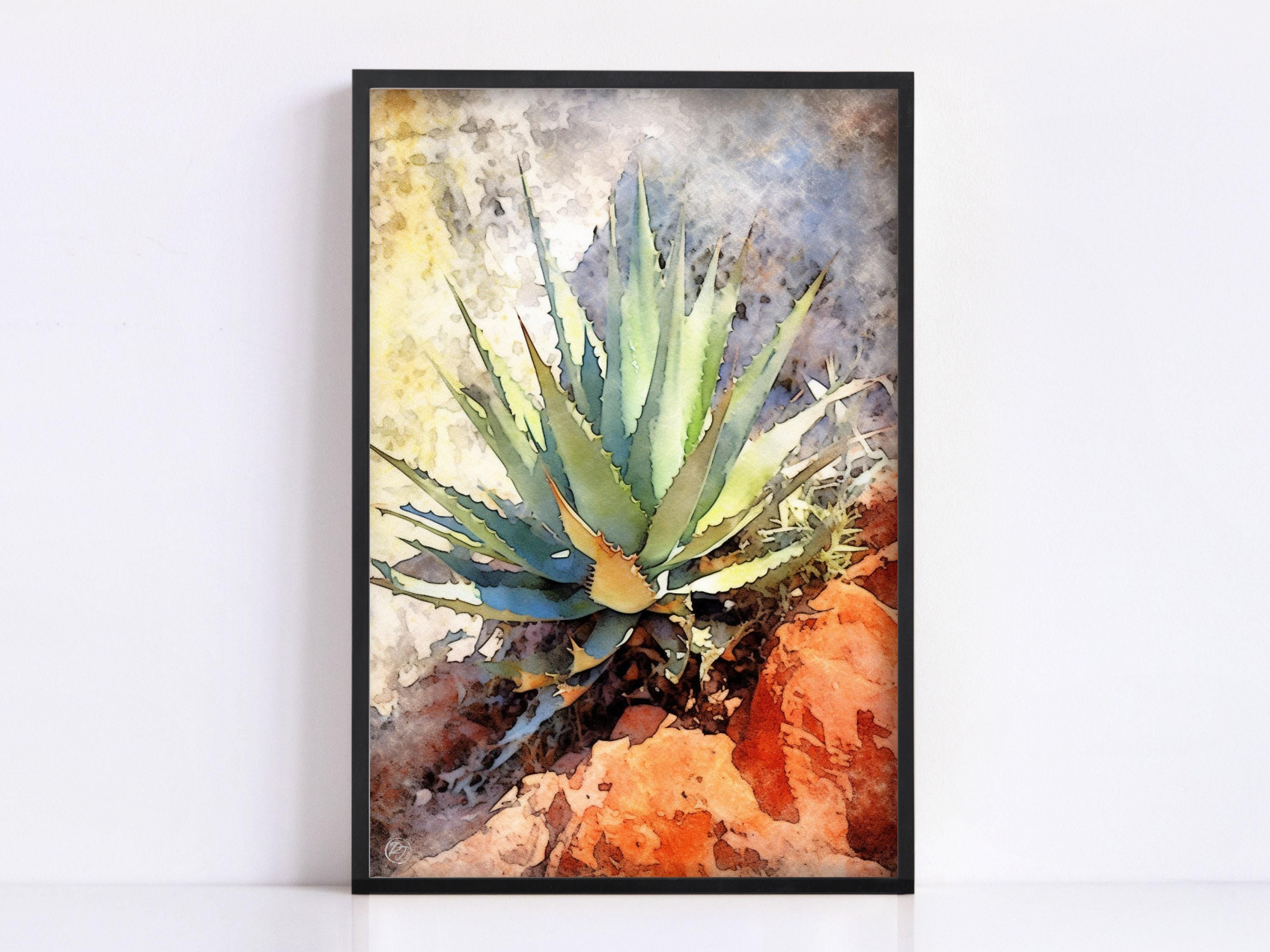 A framed watercolor painting depicting a vibrant cactus plant with long, thin leaves against a rocky background.