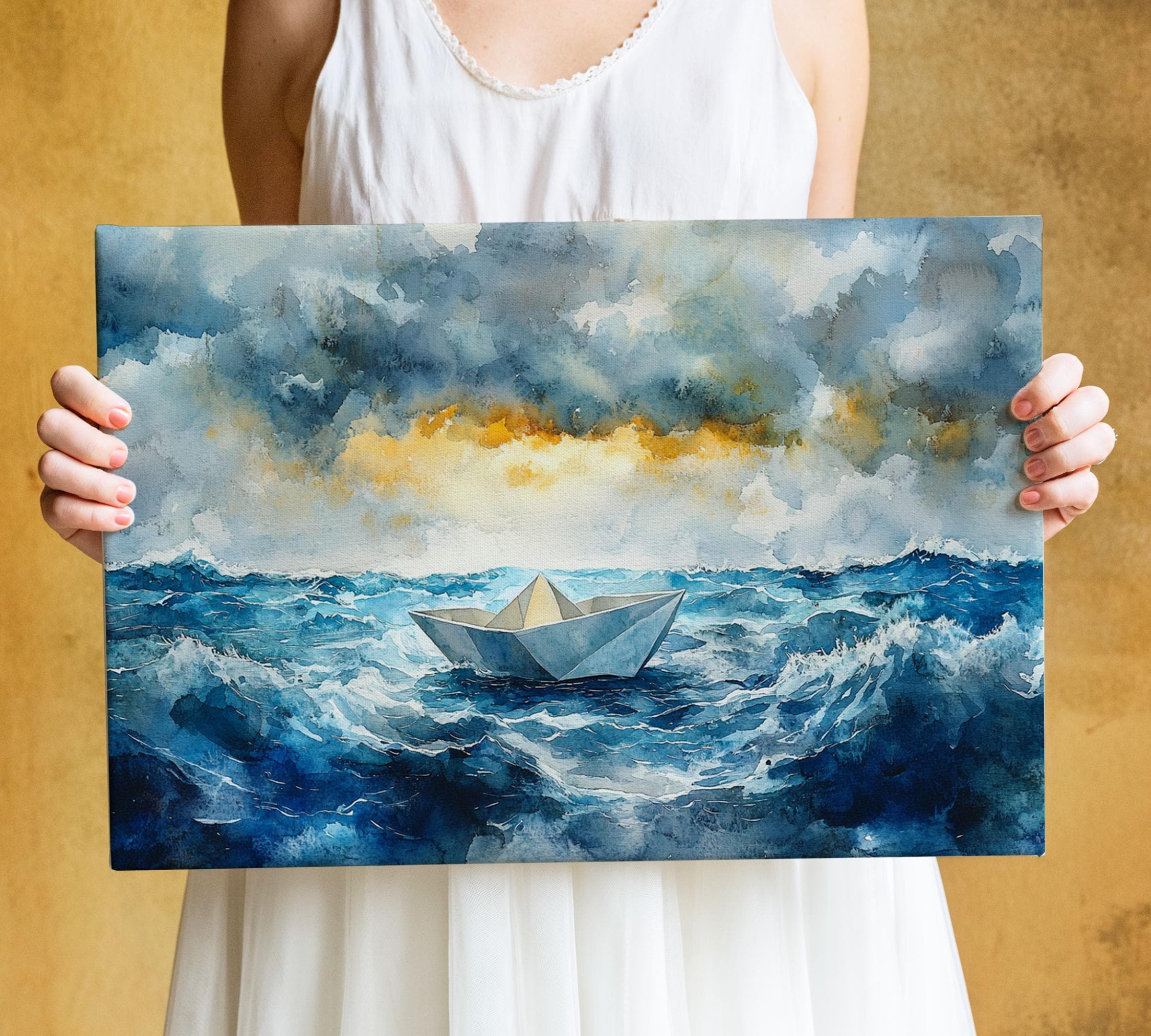 A person is holding a painting of a paper boat on a stormy sea, with a dramatic sky and crashing waves in the background.