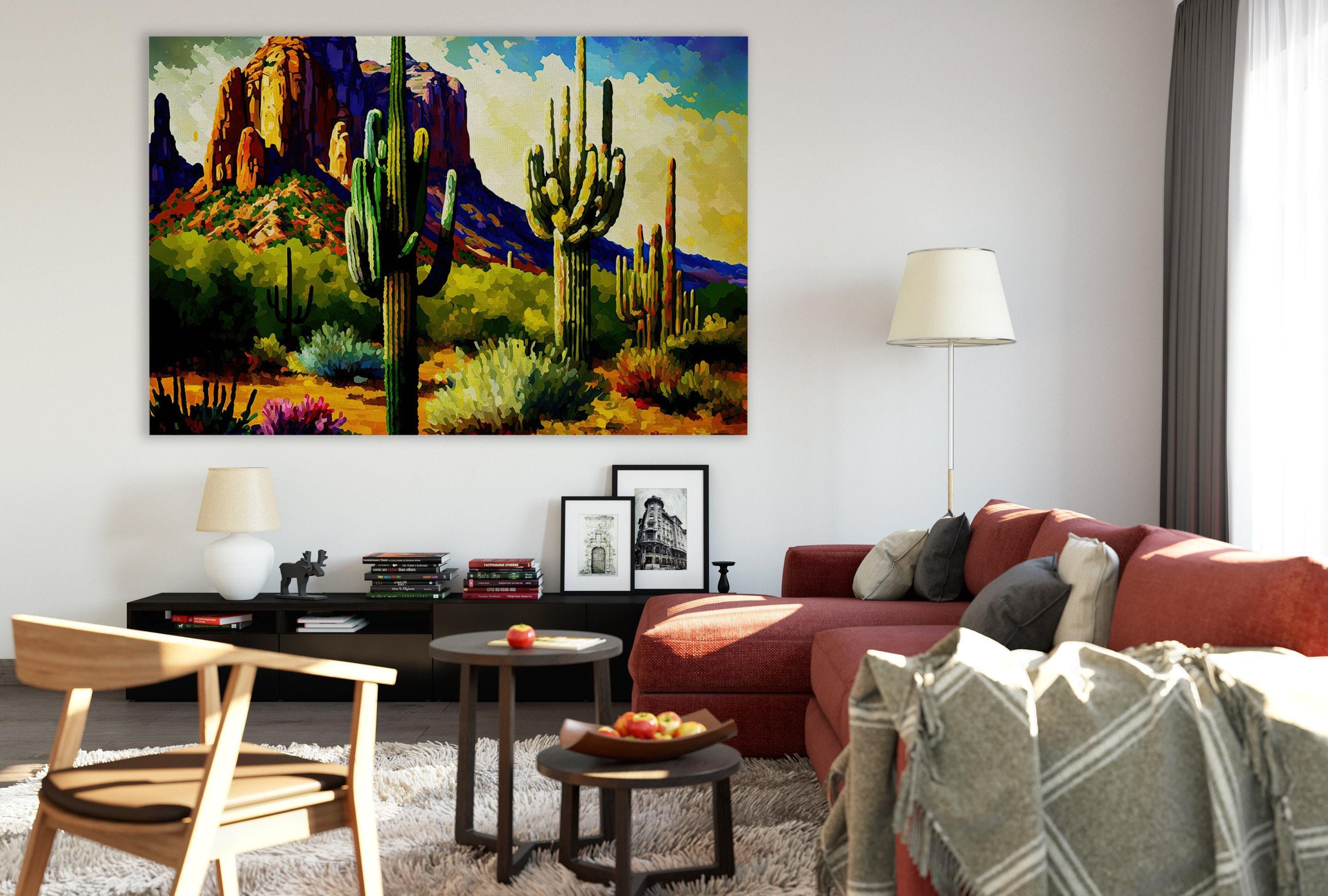 a cozy living room with a large painting of a desert landscape hanging on the wall. The room is furnished with a red couch, a wooden chair, and a coffee table with a bowl of fruit. The overall atmosphere of the room is warm and inviting, with the desert landscape painting adding a touch of nature and color to the space.