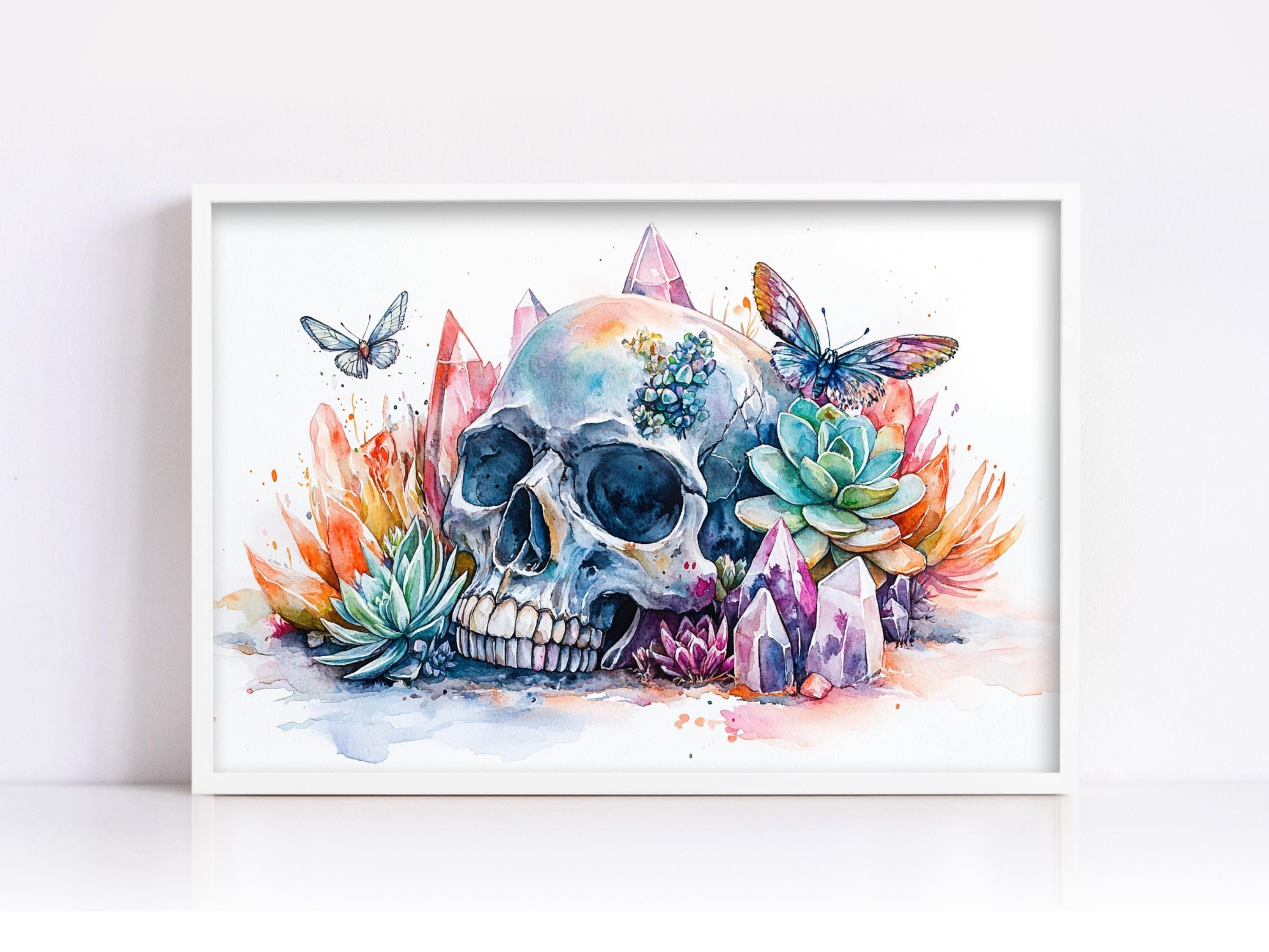 A framed watercolor painting depicting a skull surrounded by colorful flowers, butterflies, and crystals.