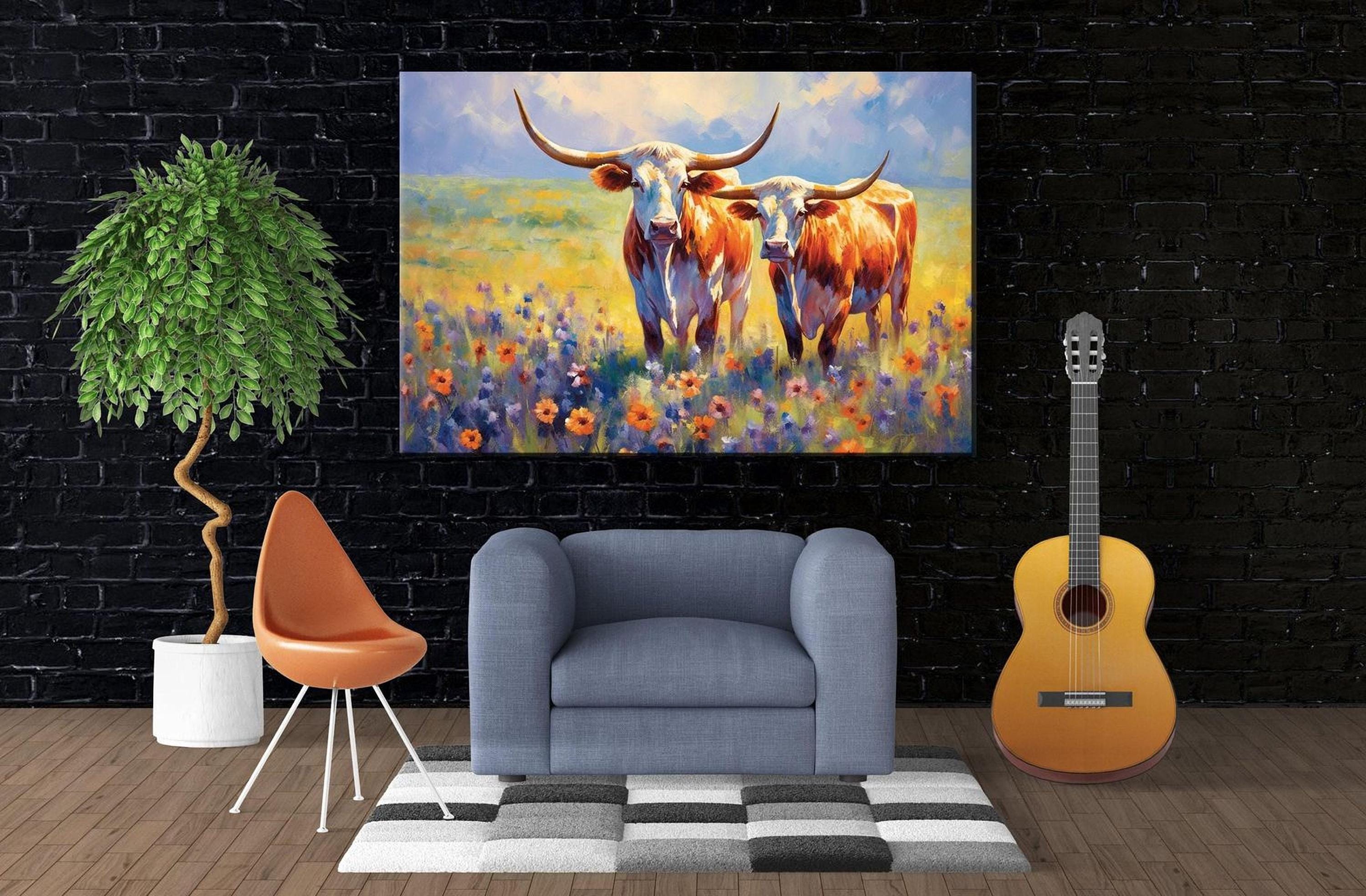 a living room with a large painting of two cows in a field hanging on the wall. The painting is vibrant and colorful, adding a lively atmosphere to the space. In the room, there is a gray armchair, a potted plant, and a guitar, creating a cozy and inviting environment.