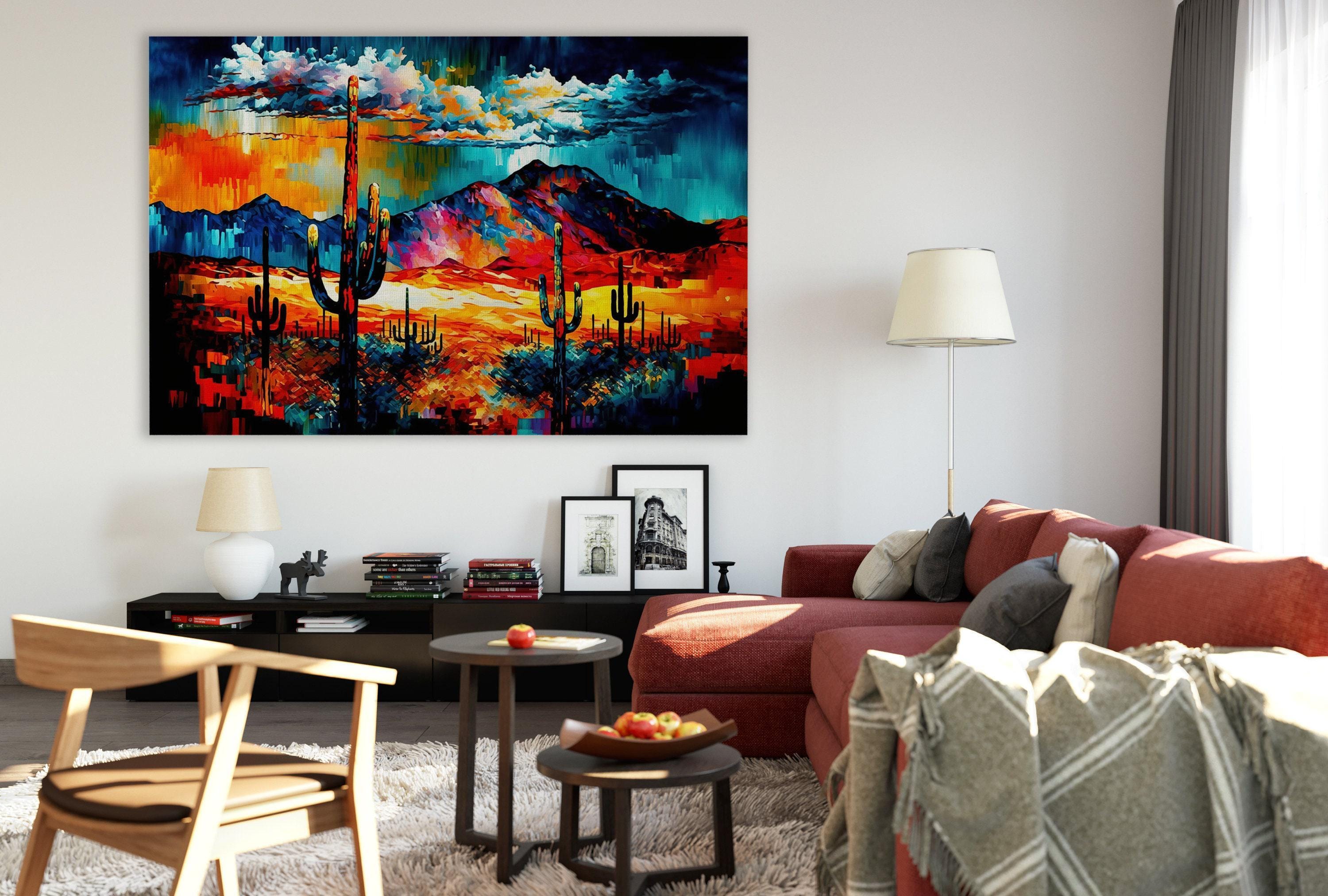 a modern living room with a large, colorful painting of a desert landscape hanging on the wall. The room is furnished with a red sofa, a wooden chair, and a coffee table with a bowl of fruit. The overall decor has a contemporary and stylish feel.