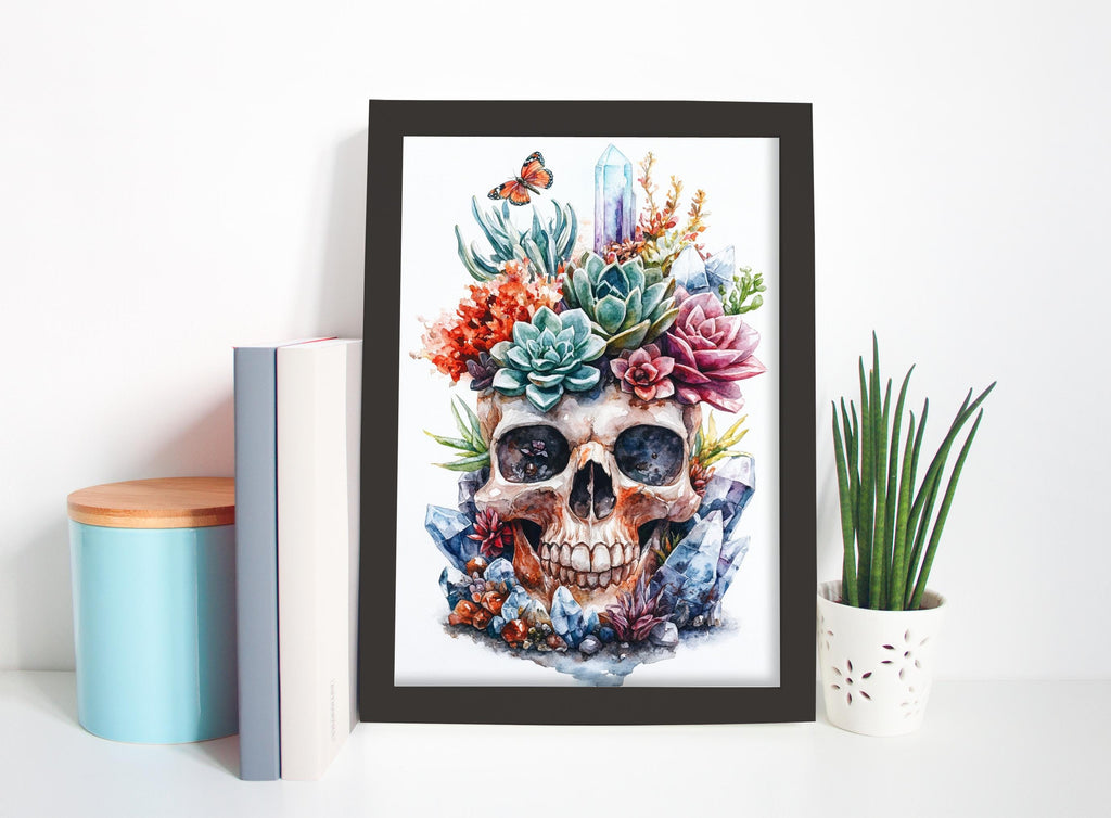 a framed painting of a skull surrounded by a variety of colorful flowers and plants, placed on a shelf next to some books and a potted plant.