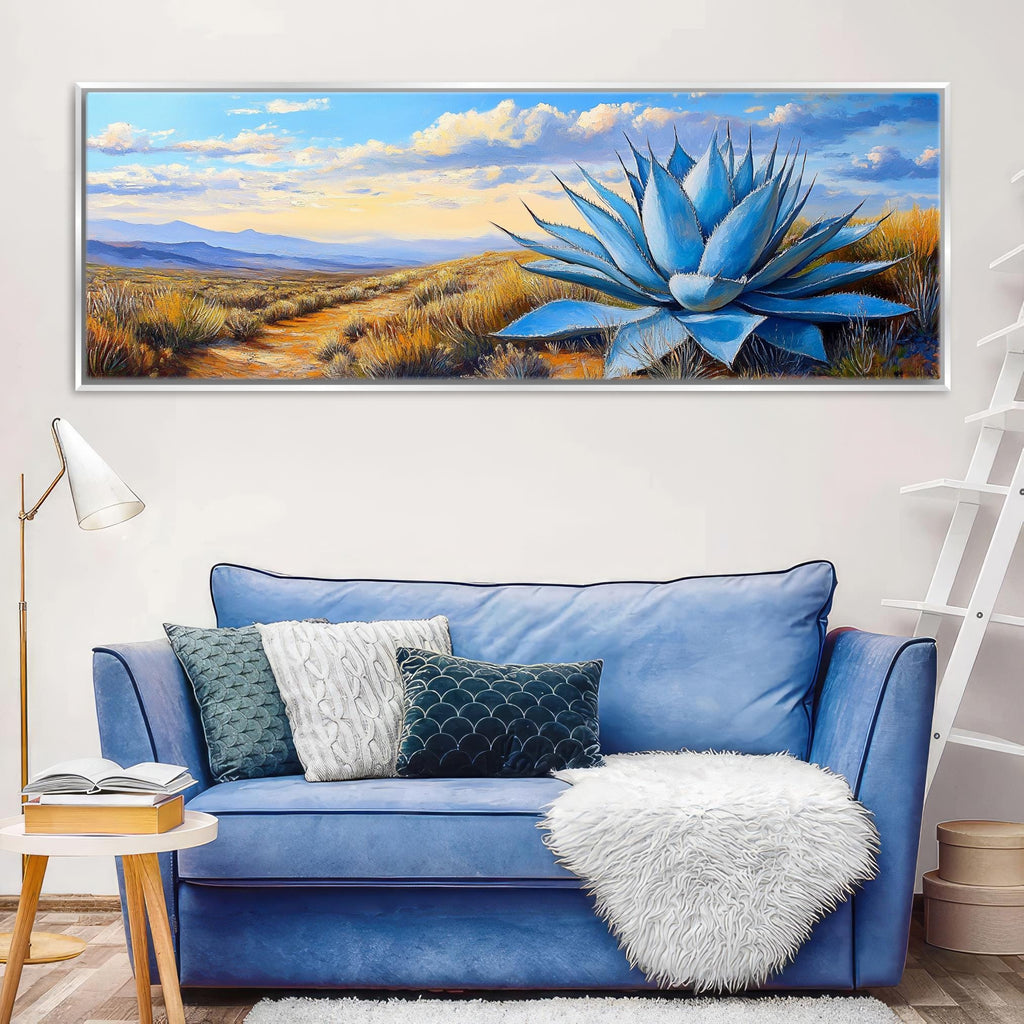 a blue couch in a living room with a painting on the wall