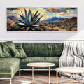 a living room with a green couch and a painting on the wall