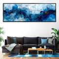 a living room with a couch and a painting on the wall