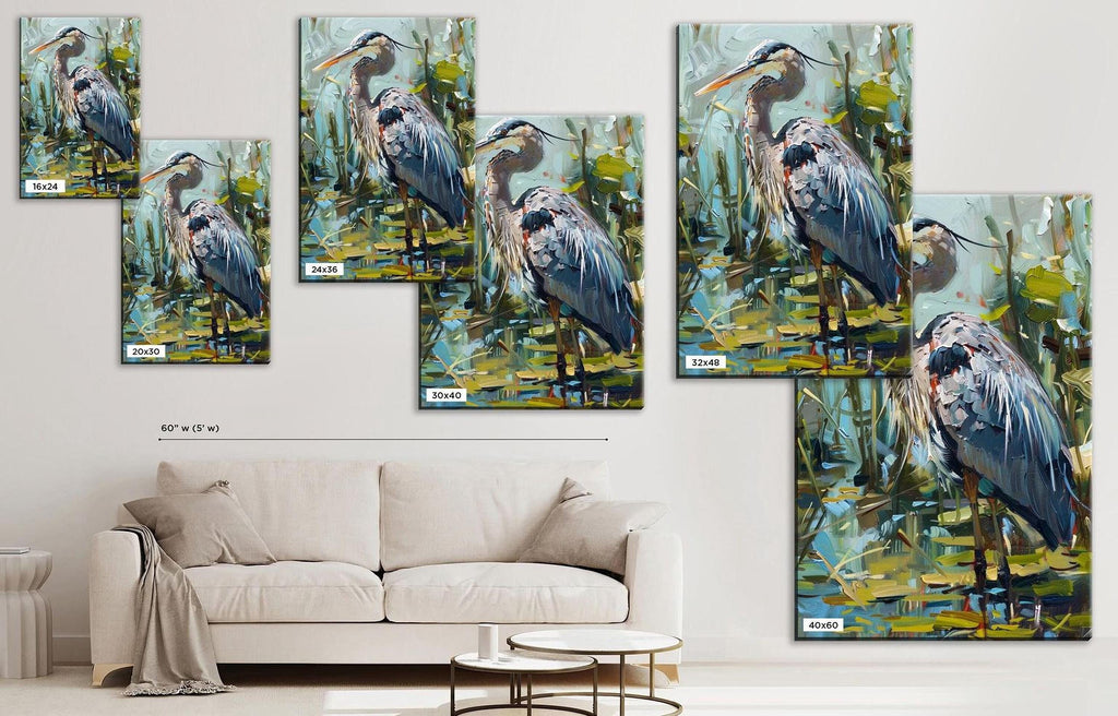 The image is a collage of multiple paintings of blue herons, displayed on a wall above a white couch in a living room setting.