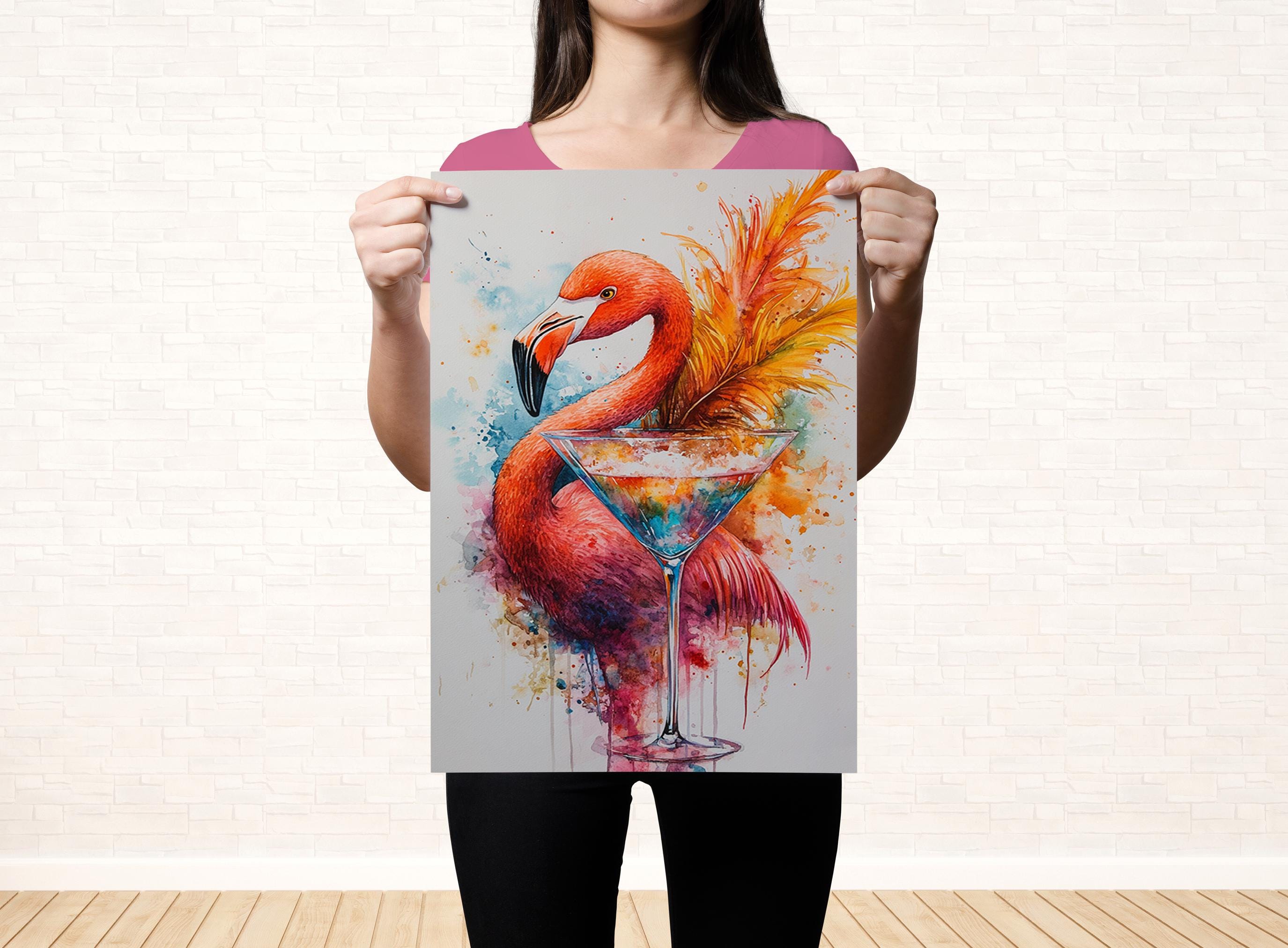 A woman holds up a poster featuring a vibrant painting of a flamingo with a martini glass.
