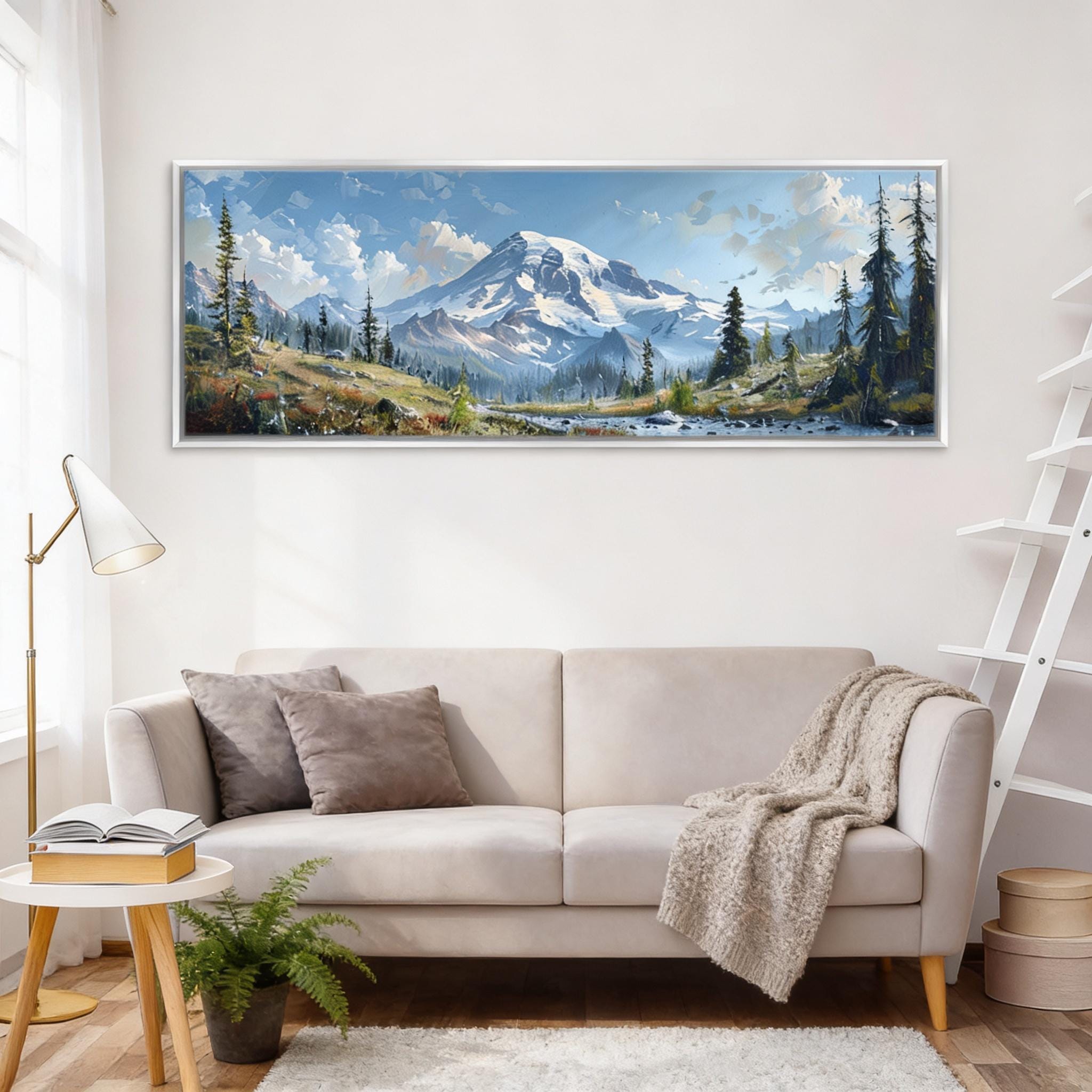 a large landscape painting hanging on a white wall above a beige sofa in a cozy living room setting.