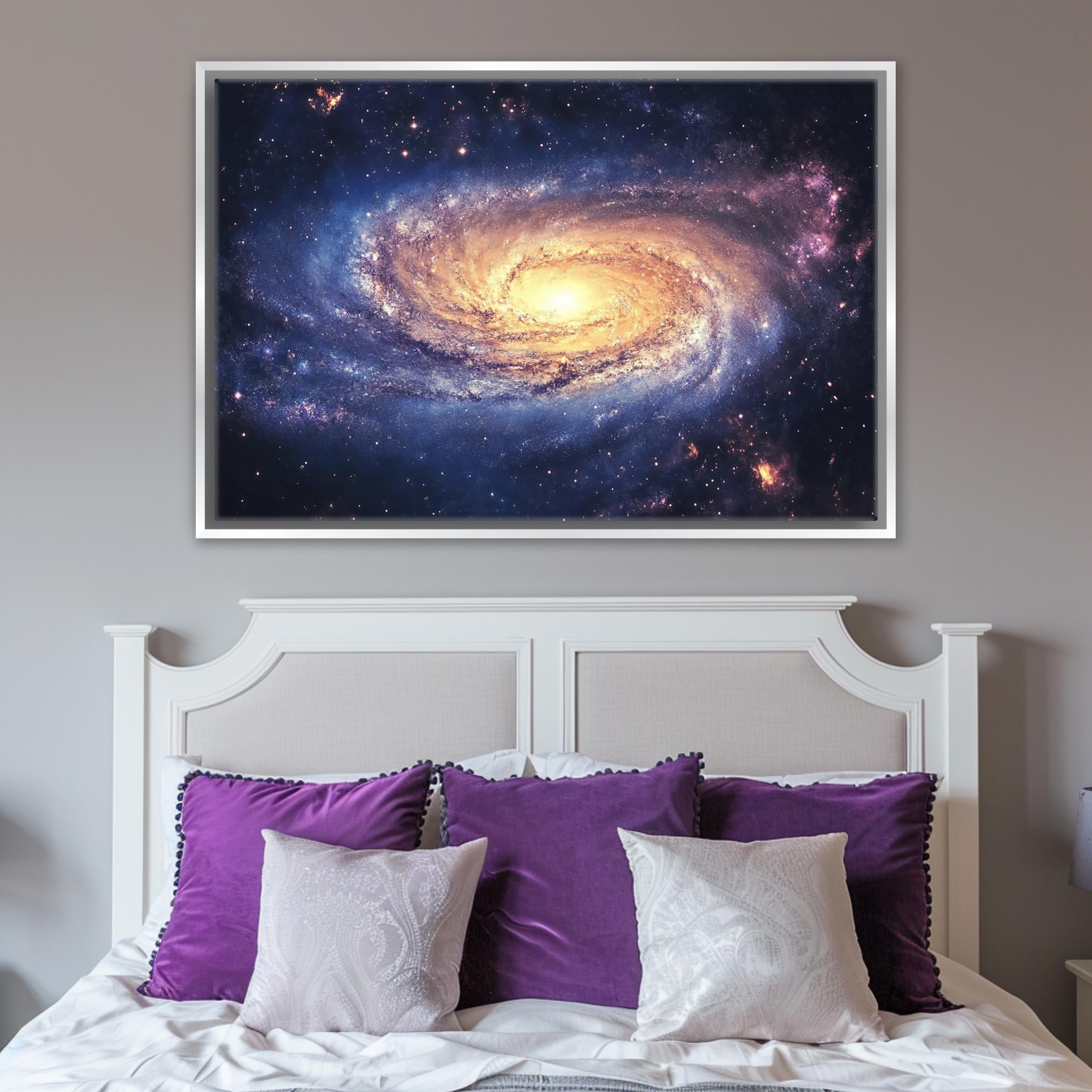 a picture of a spiral galaxy hangs above a bed