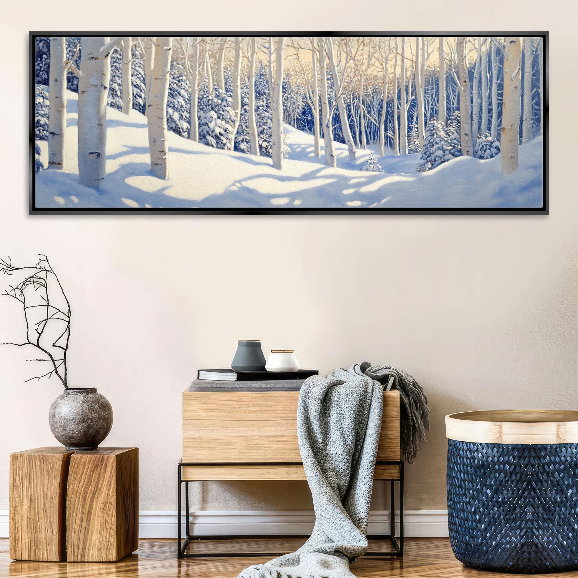 a painting of a snowy forest in a living room