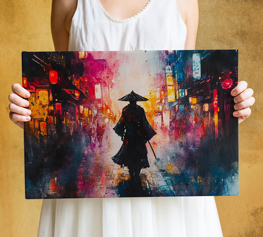 A person is holding a large painting depicting a person in a black outfit and hat walking down a city street at night, with colorful lights and buildings in the background.