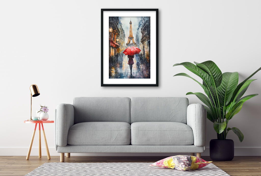 a gray sofa, a framed painting of a rainy street scene with a red umbrella, a small table with a lamp, and a potted plant.