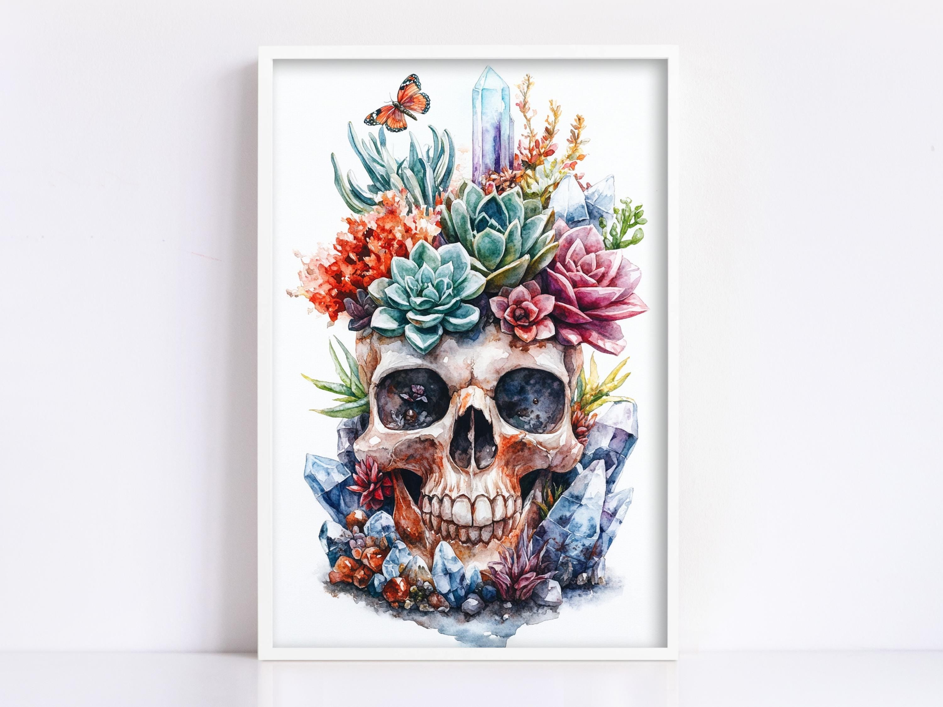 The image is a framed artwork depicting a skull surrounded by a variety of colorful flowers, plants, and crystals.