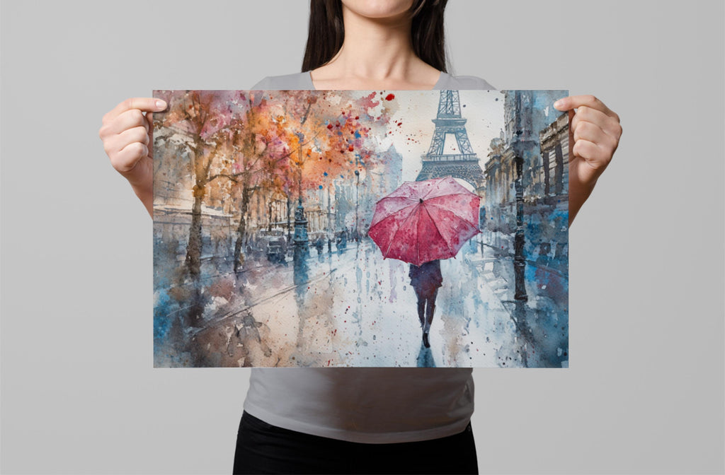 A woman holds up a framed painting depicting a person walking with a red umbrella in front of the Eiffel Tower on a rainy day in Paris.