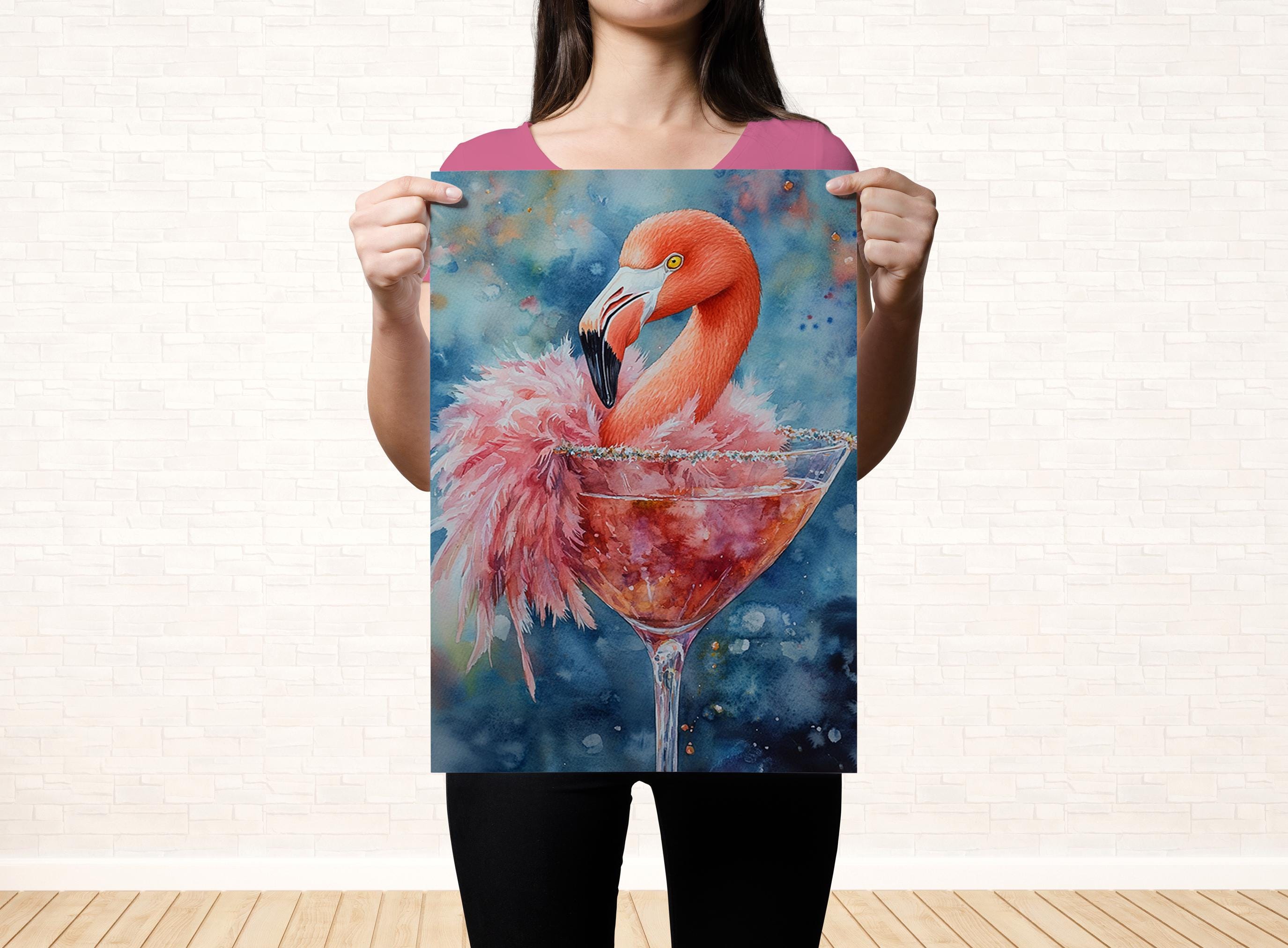 A woman holds up a framed painting of a flamingo in a martini glass, with a pink and blue background.