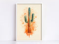 The image is a framed watercolor painting of a cactus with a vibrant orange and green color scheme, surrounded by orange splatters.