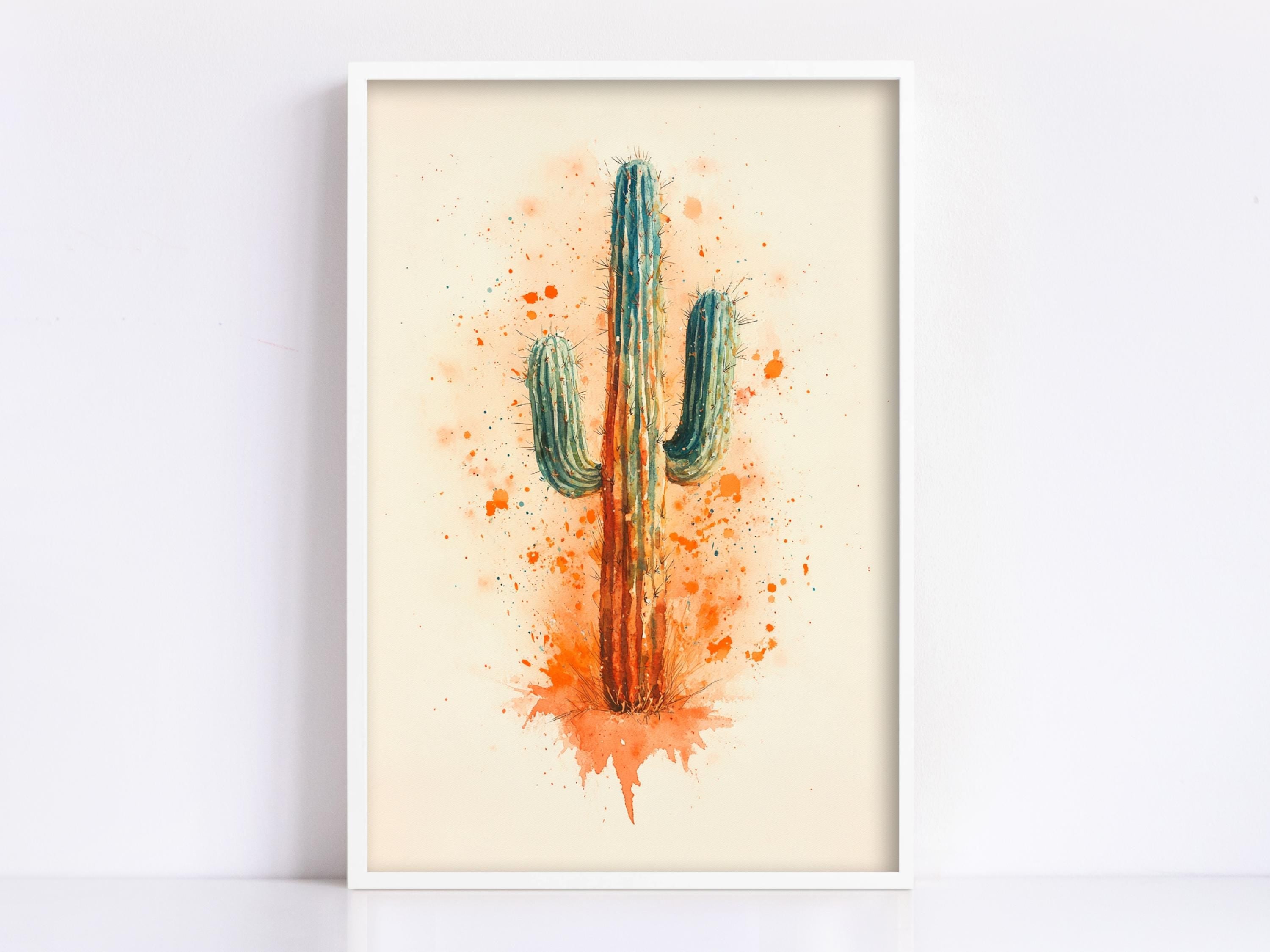 The image is a framed watercolor painting of a cactus with a vibrant orange and green color scheme, surrounded by orange splatters.