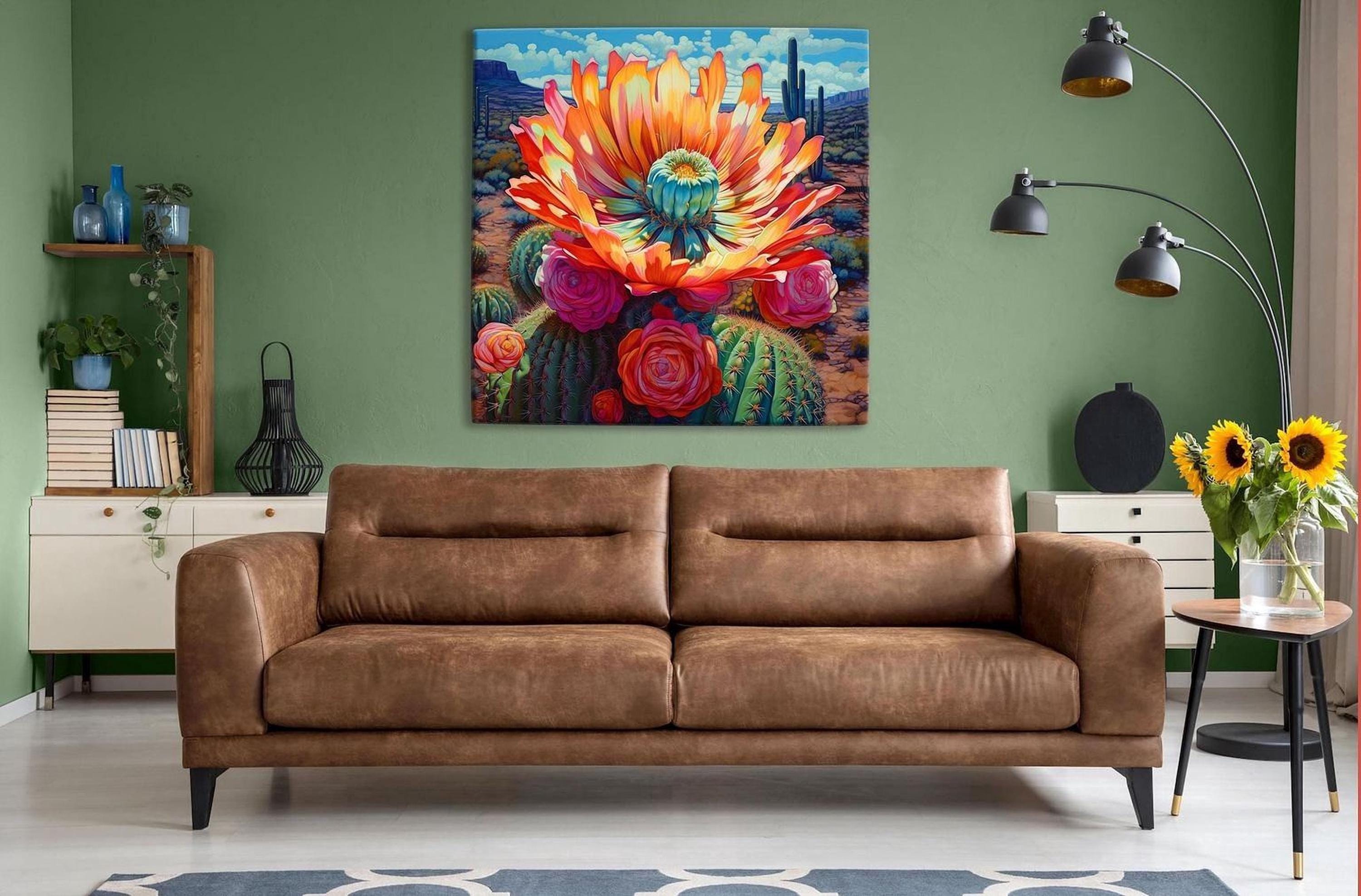 a large, colorful painting of a cactus flower hanging on a green wall above a brown leather couch in a cozy living room setting.