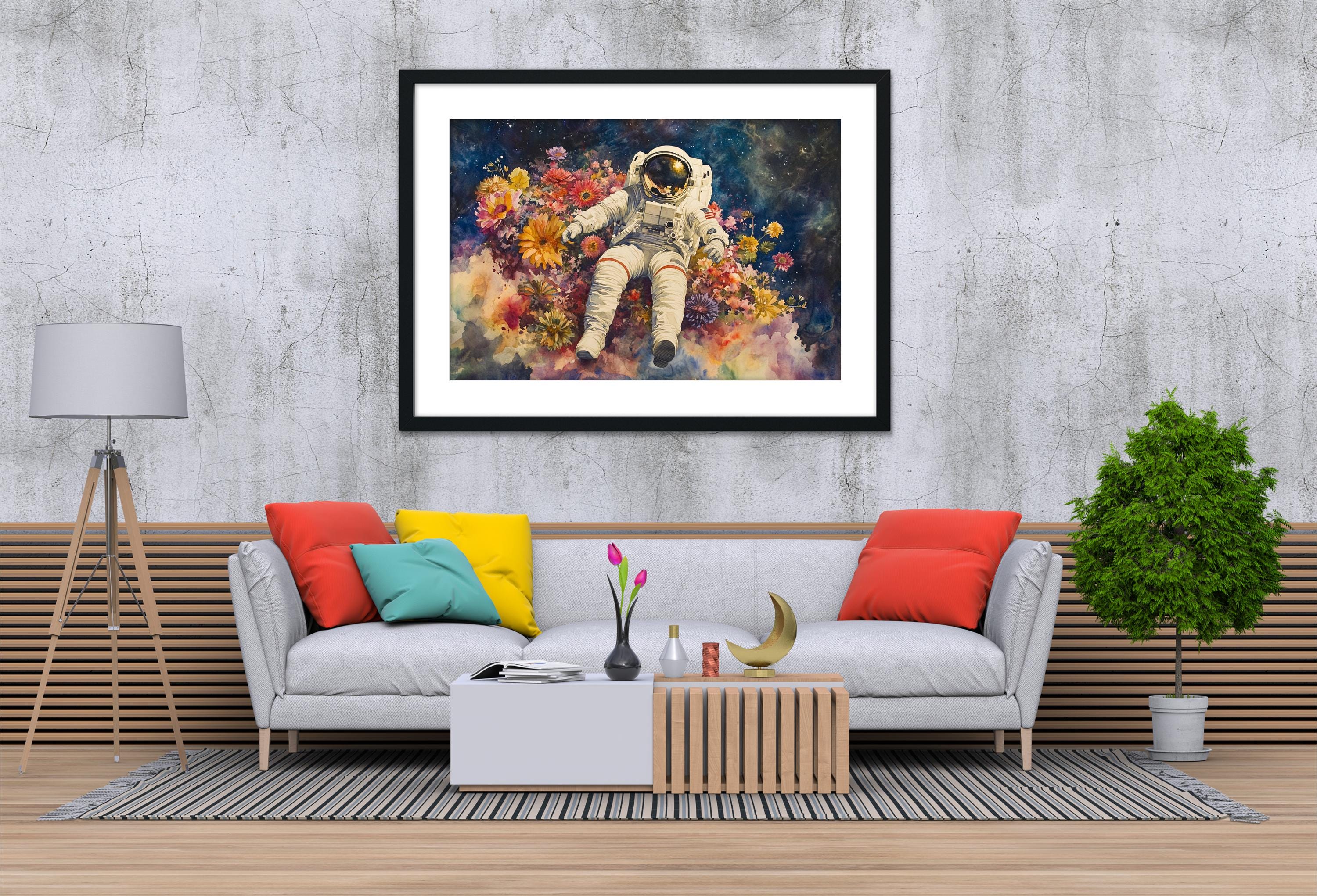 a living room with a gray sofa, a coffee table, and a framed painting of an astronaut floating in a colorful space scene.