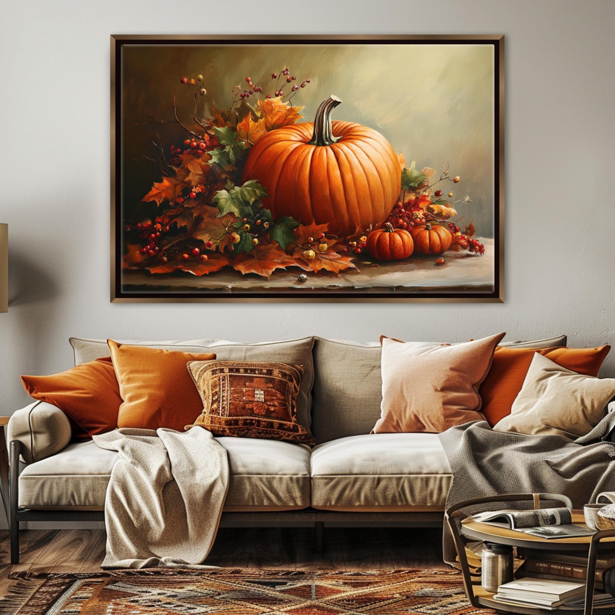 a large painting of a pumpkin and autumn leaves hanging on a wall above a couch with orange and beige pillows.