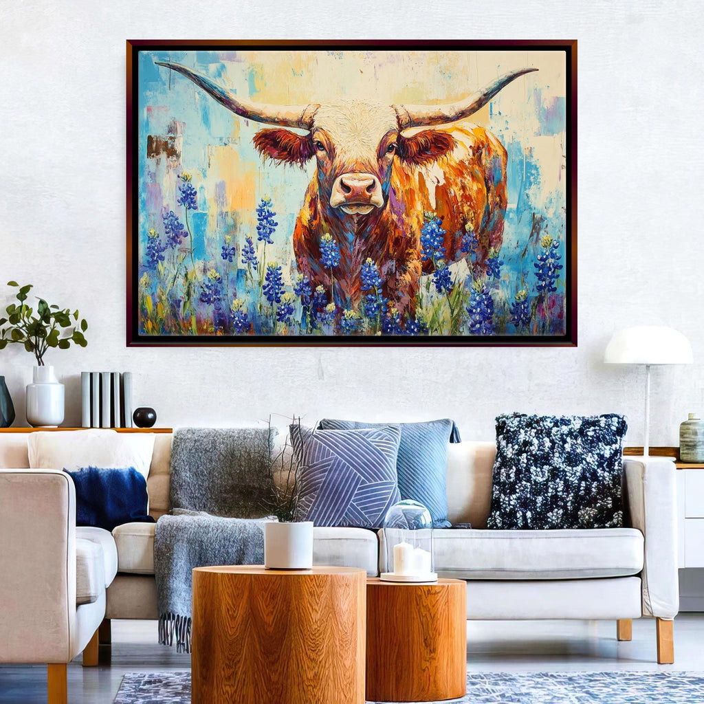 a large painting of a bull with horns, surrounded by a field of blue flowers, hanging on a wall above a couch with throw pillows.