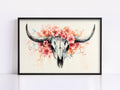 A framed painting depicting a skull with large horns and a floral arrangement surrounding it.