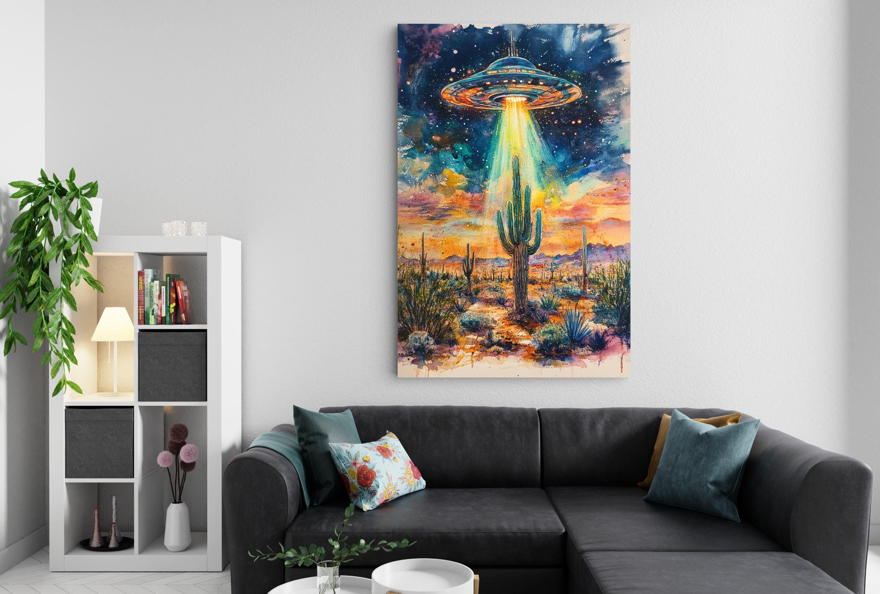 a large, colorful painting of an alien spacecraft hovering over a desert landscape, with a cactus in the foreground and a bookshelf in the background.