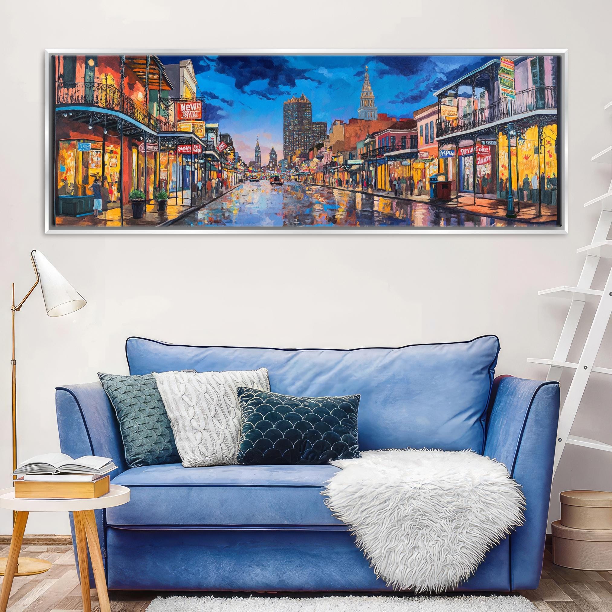 a living room with a blue couch and a painting on the wall