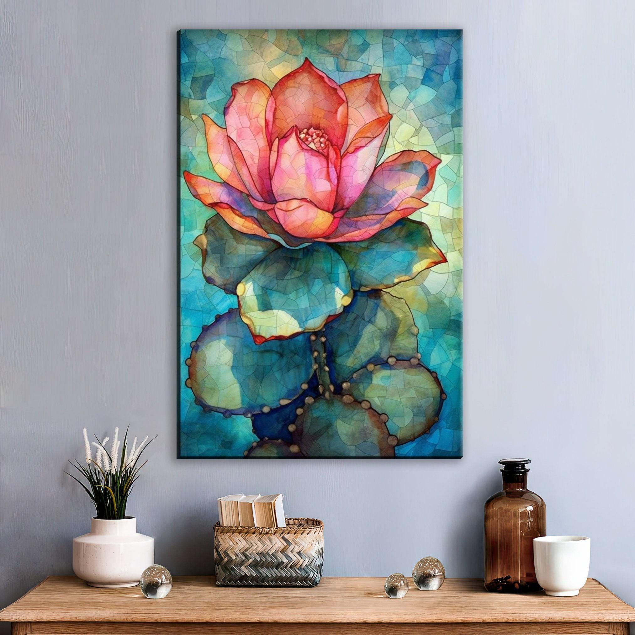 a vibrant painting of a cactus flower hanging on a wall above a wooden table with various decorative items, including a vase, a bottle, and a basket.