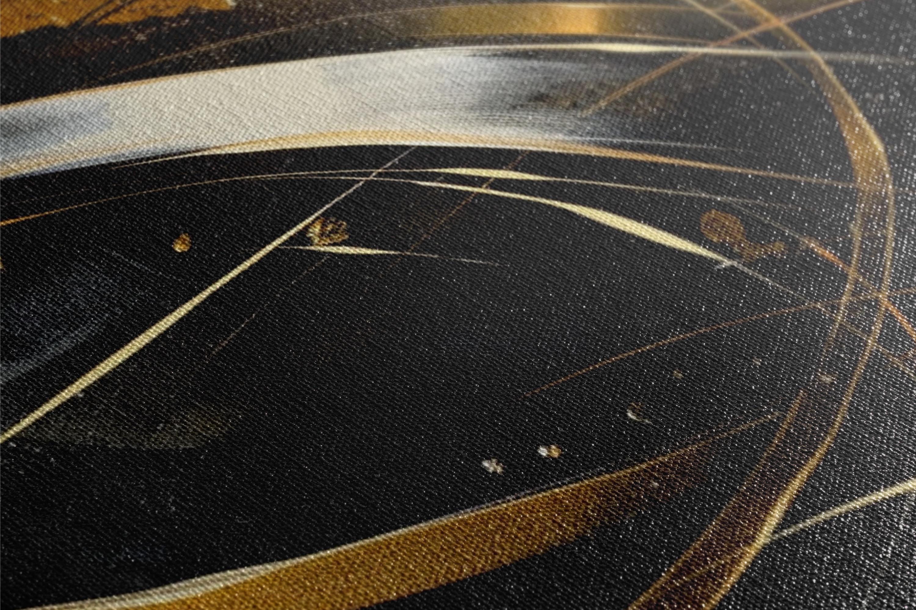 a close up of a black and gold painting
