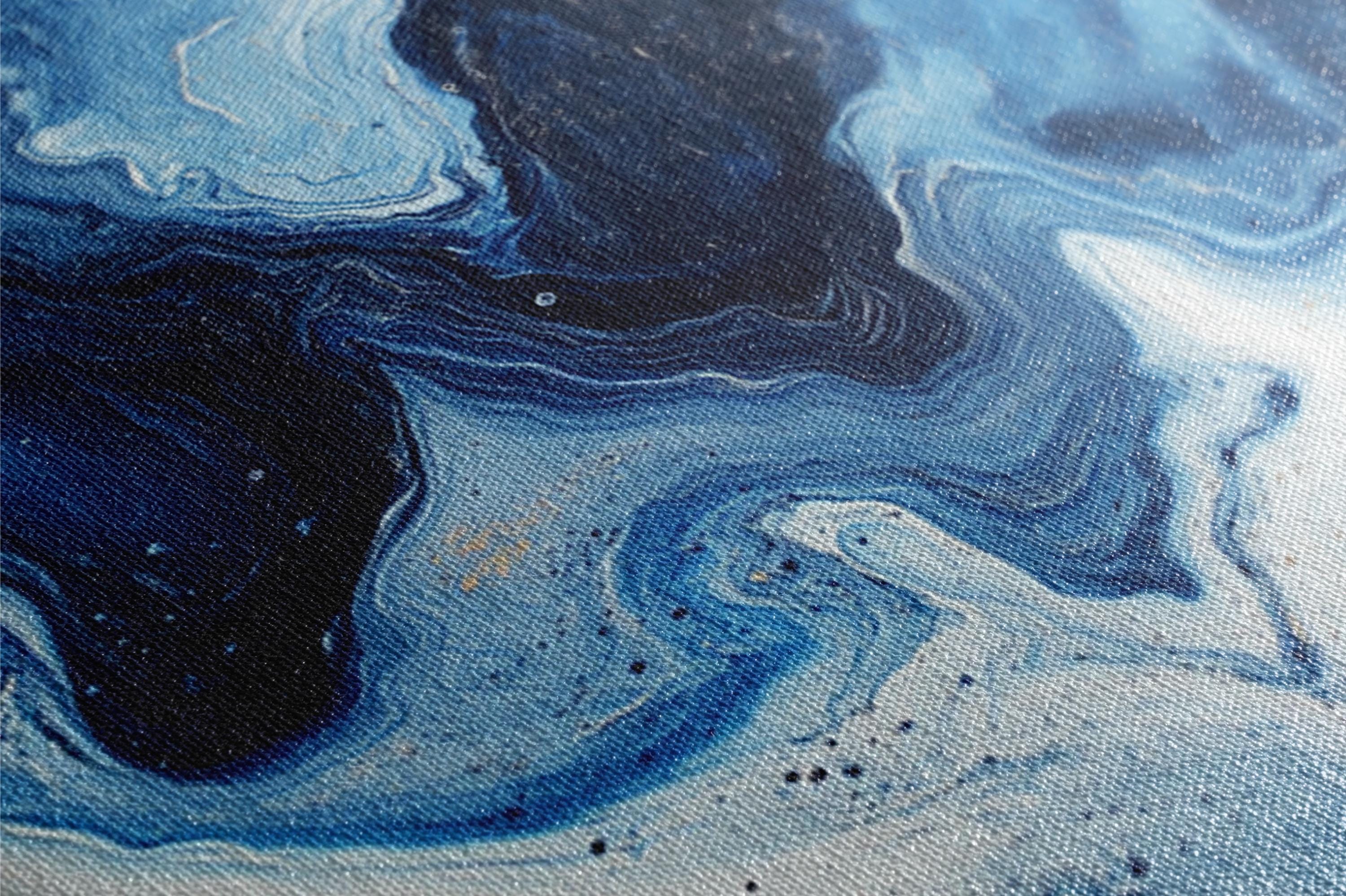 a close up of a blue and black painting