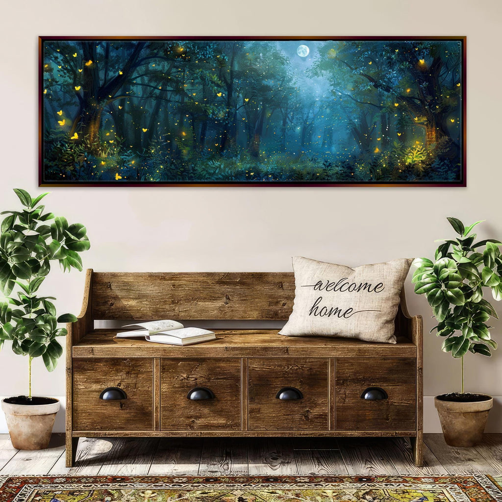 a large, framed painting of a forest scene with a full moon, surrounded by trees with glowing fireflies. The painting is hung on a wall above a wooden bench with a "welcome home" pillow. The bench is situated in front of two potted plants, and there is a rug on the floor beneath it.