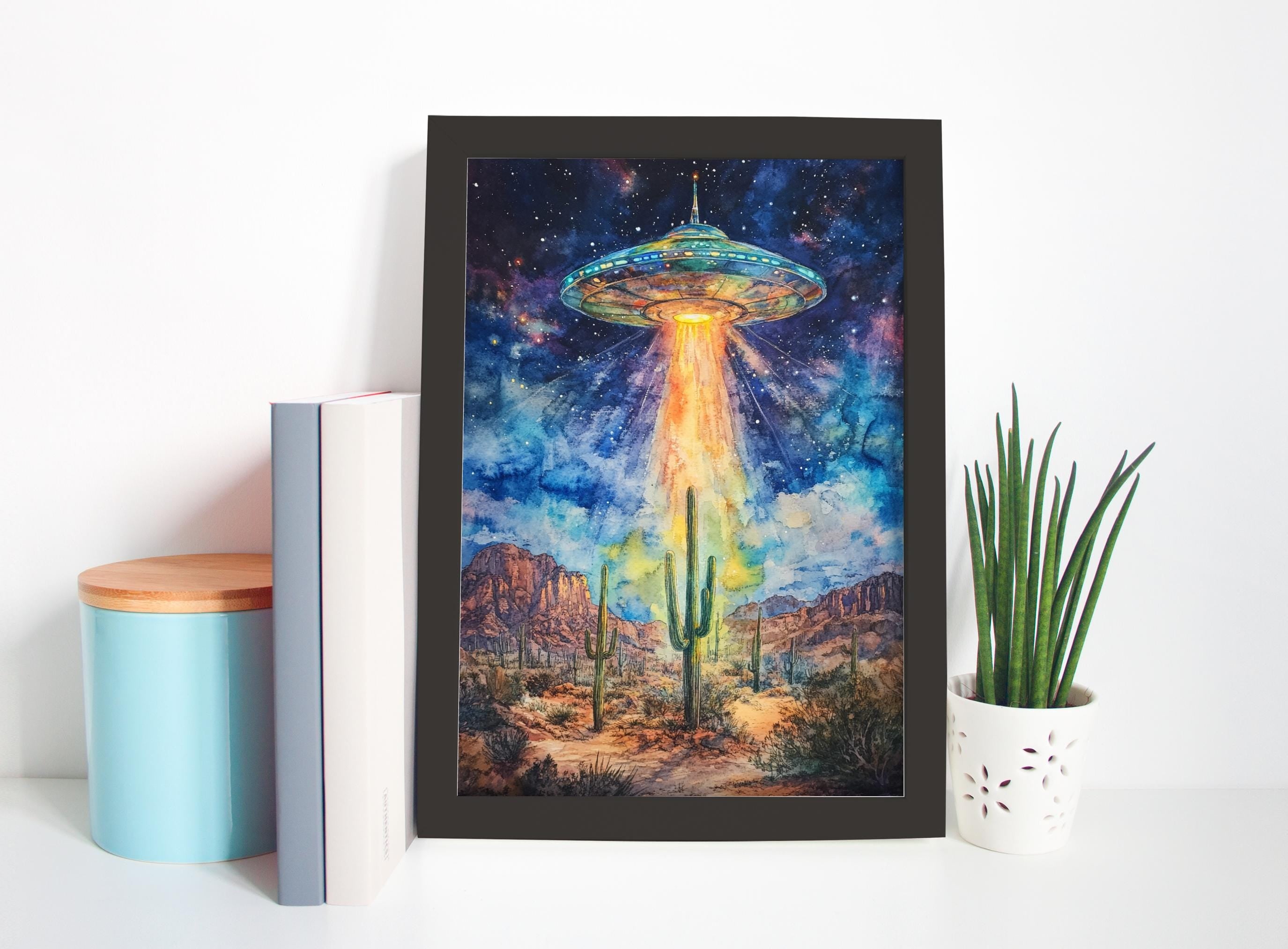 a framed painting of a desert landscape with a large alien spacecraft hovering above it, surrounded by cacti and mountains.