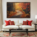 a large painting of a forest path with autumn foliage hanging on a wall above a white sofa with red throw pillows.